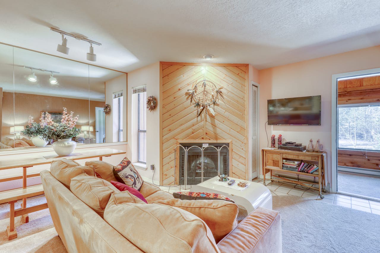 Angel Fire, NM vacation rental with wood paneled fireplace with a dream catcher mounted above