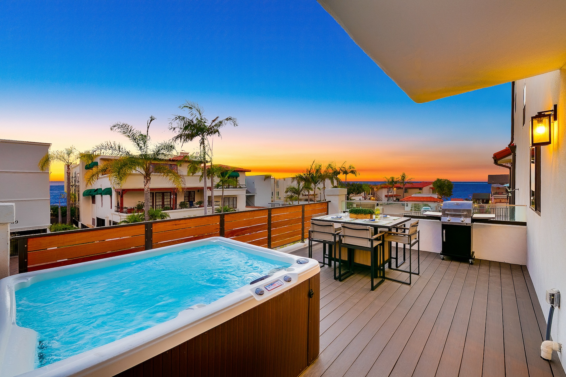 The deck with a hot tub during a sunset at a vacation rental in San Clemente, CA.