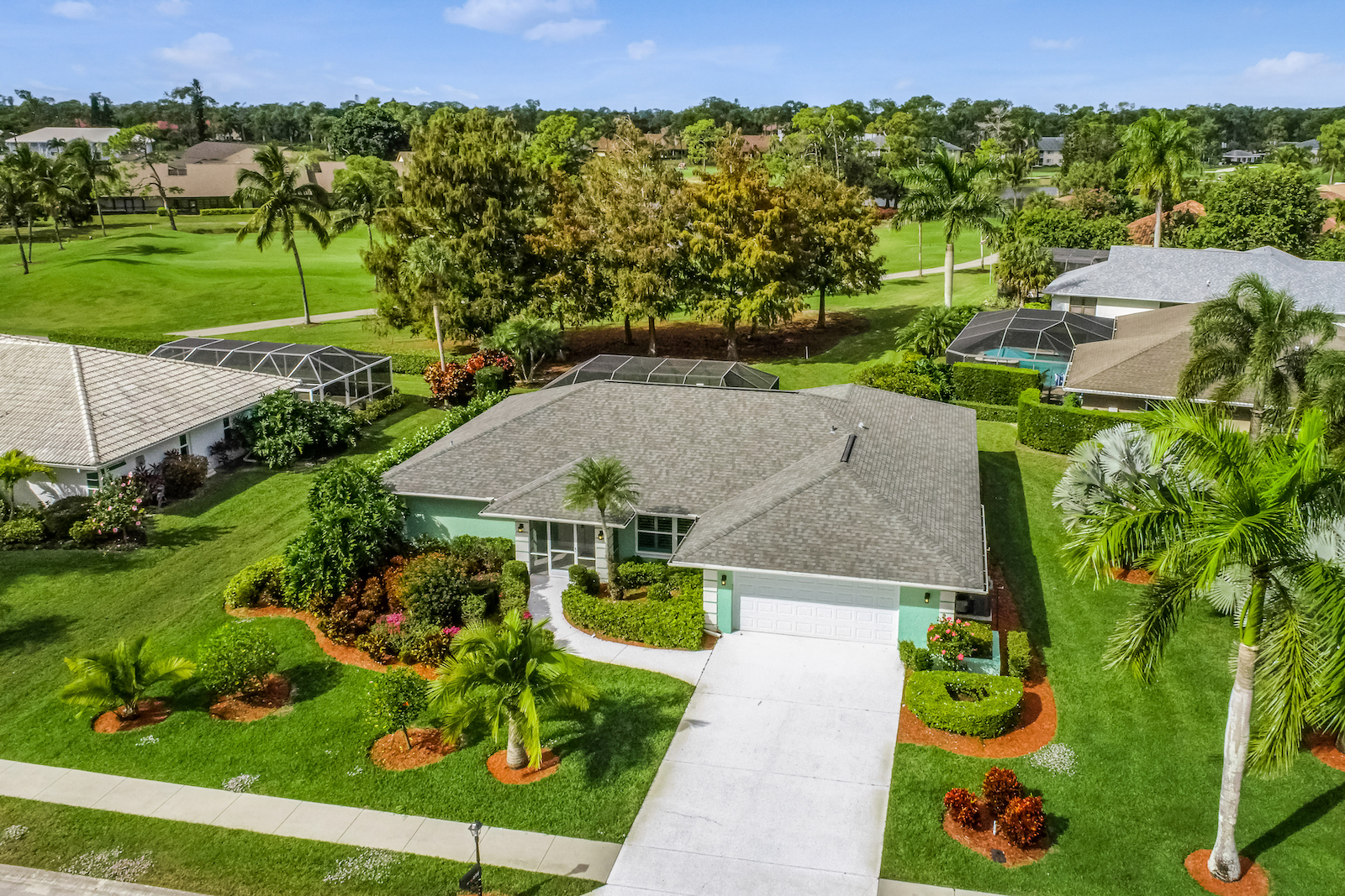 A drone shot of a vacation rental in Naples on a golf course.