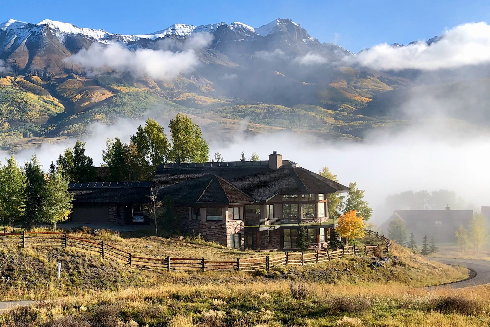 Drone shot of a home rental in Mountain Village, CO that overlooks the mountains.