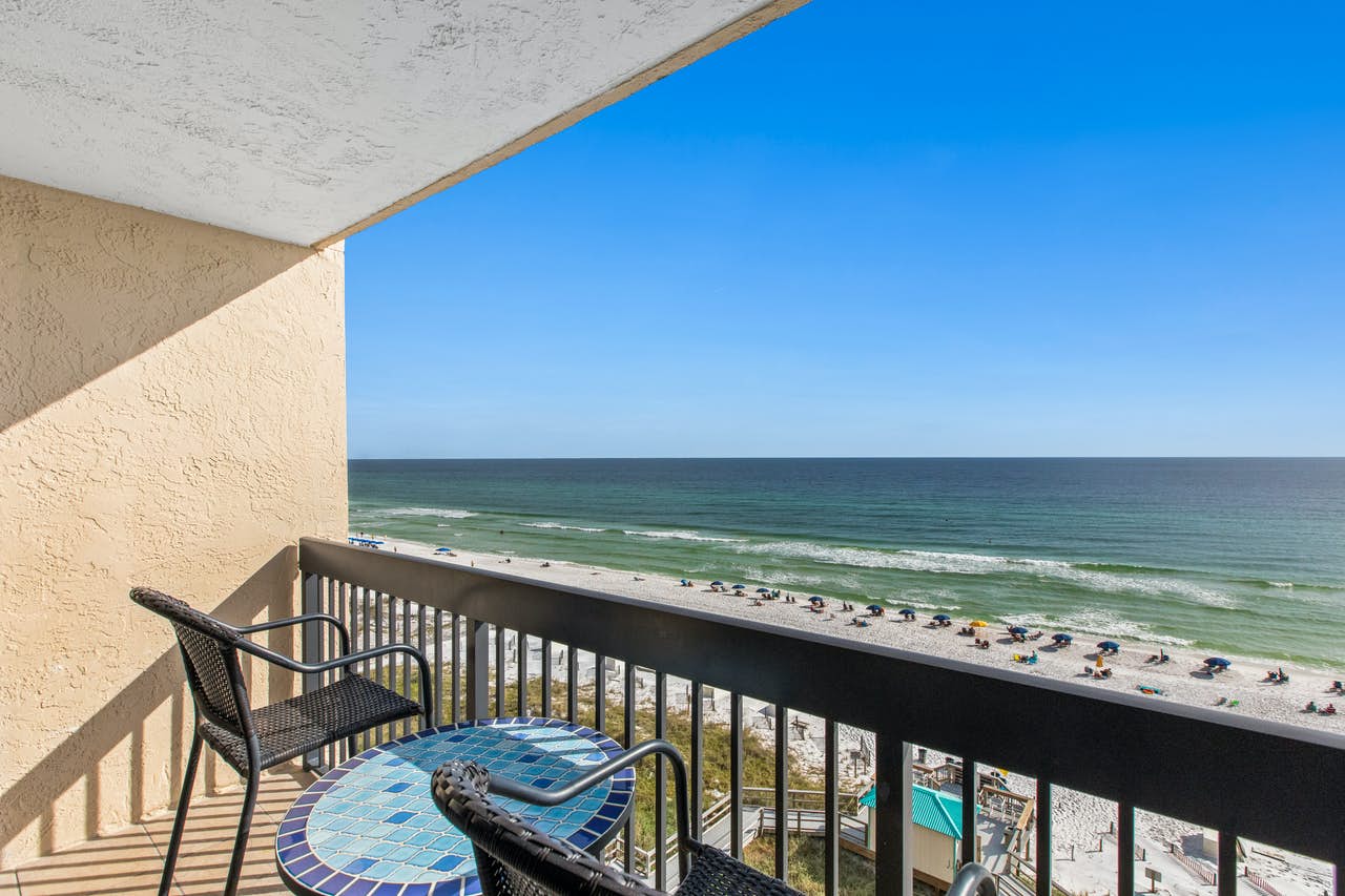 A balcony overlooking the beach with people in Destin, FL.