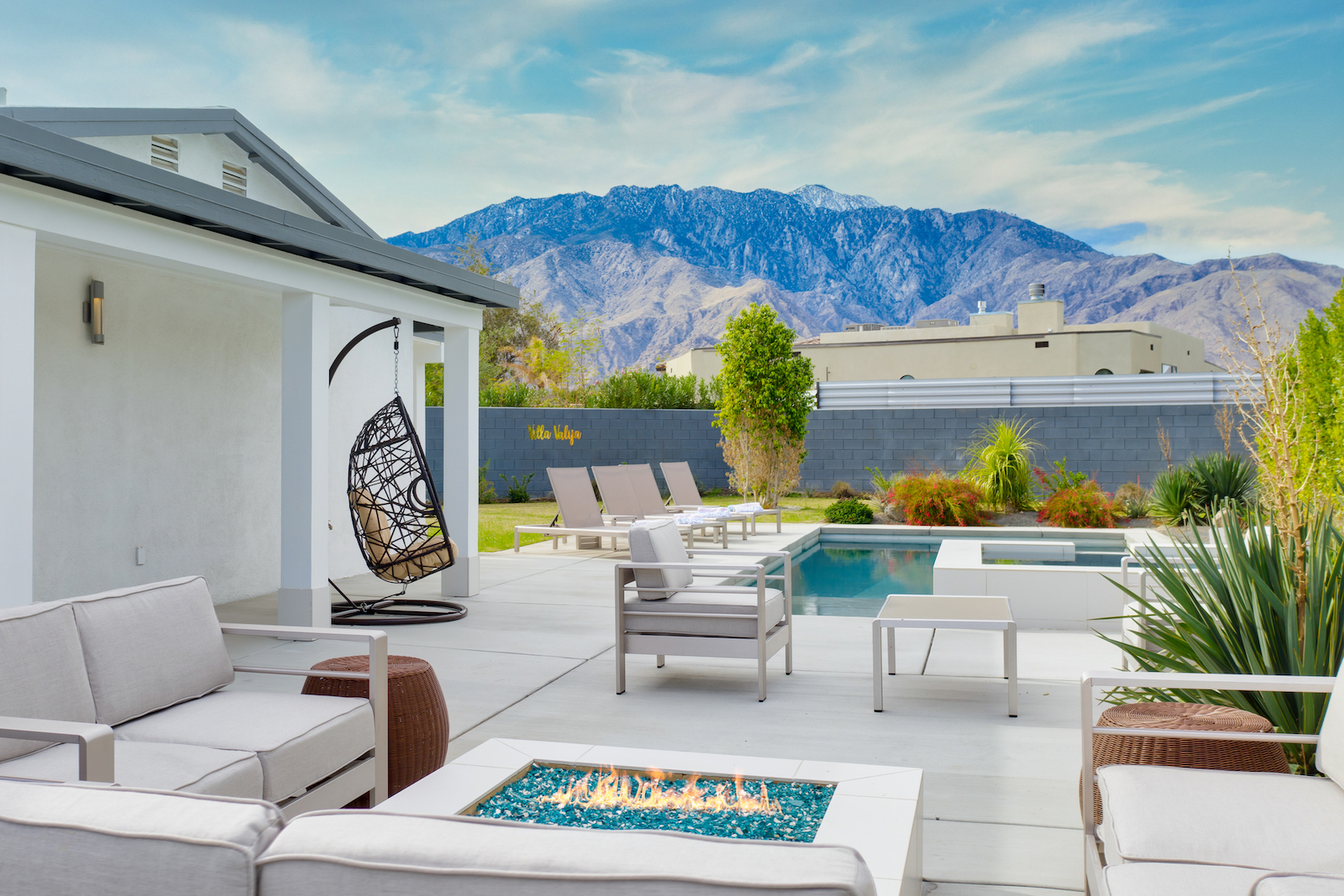 The back pool area with a fire pit at a vacation rental in Palm Springs, CA.