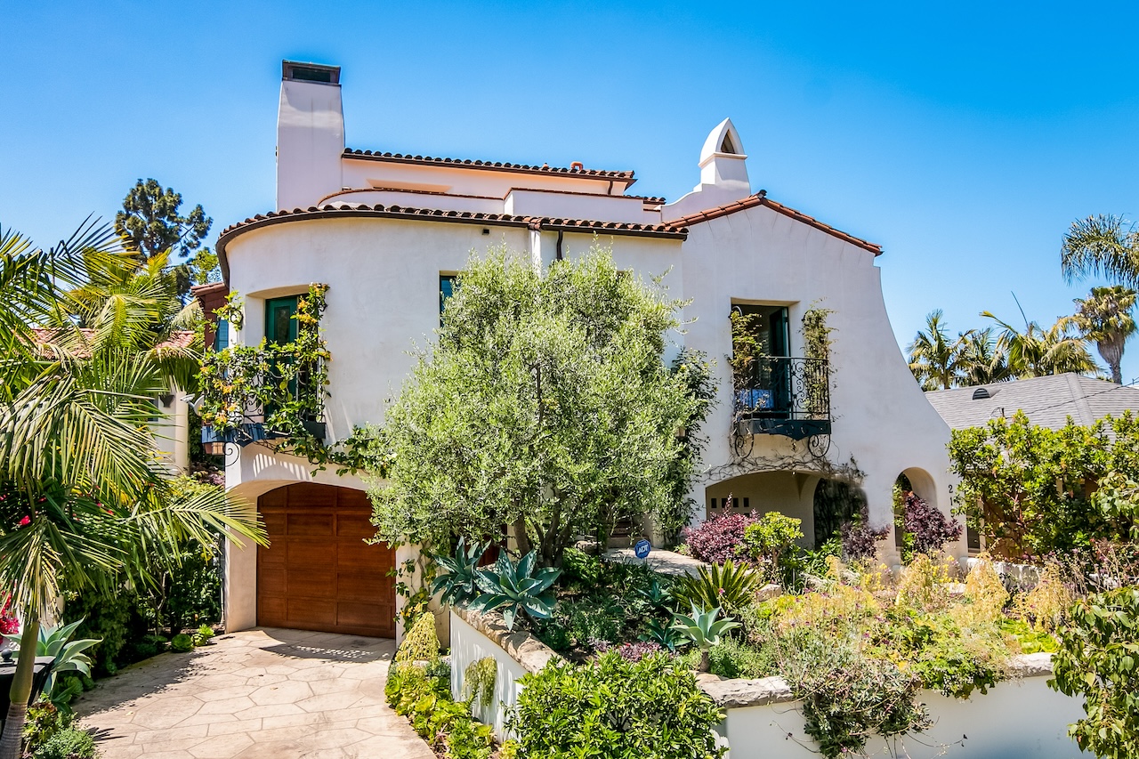 The exterior of a vacation rental in Santa Barbara surrounded by exotic plants.