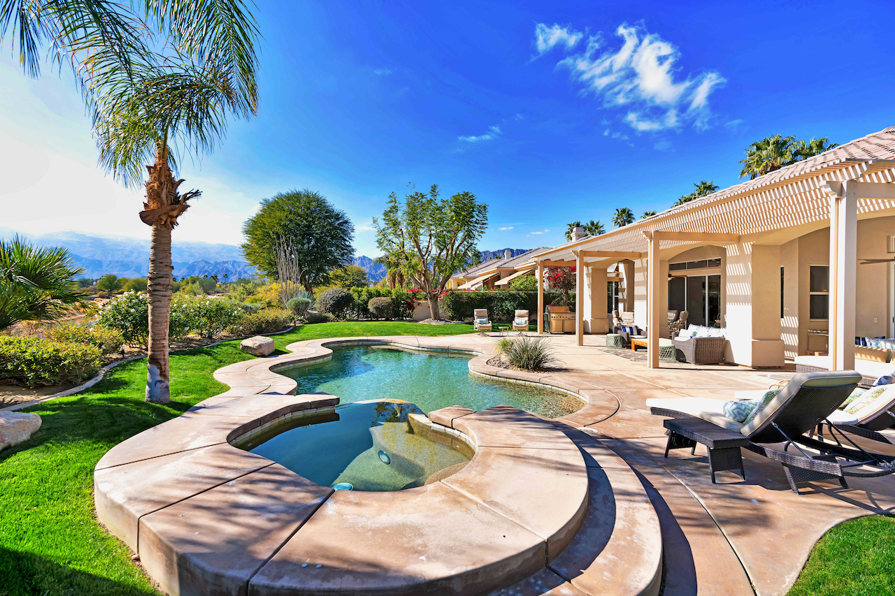 A vacation rental with a hot tub and a pool in La Quinta, CA.