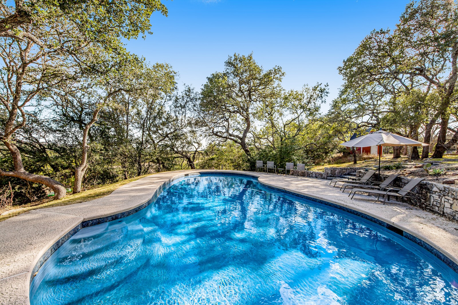 The pool area of a vacation rental in Dripping Springs, TX.