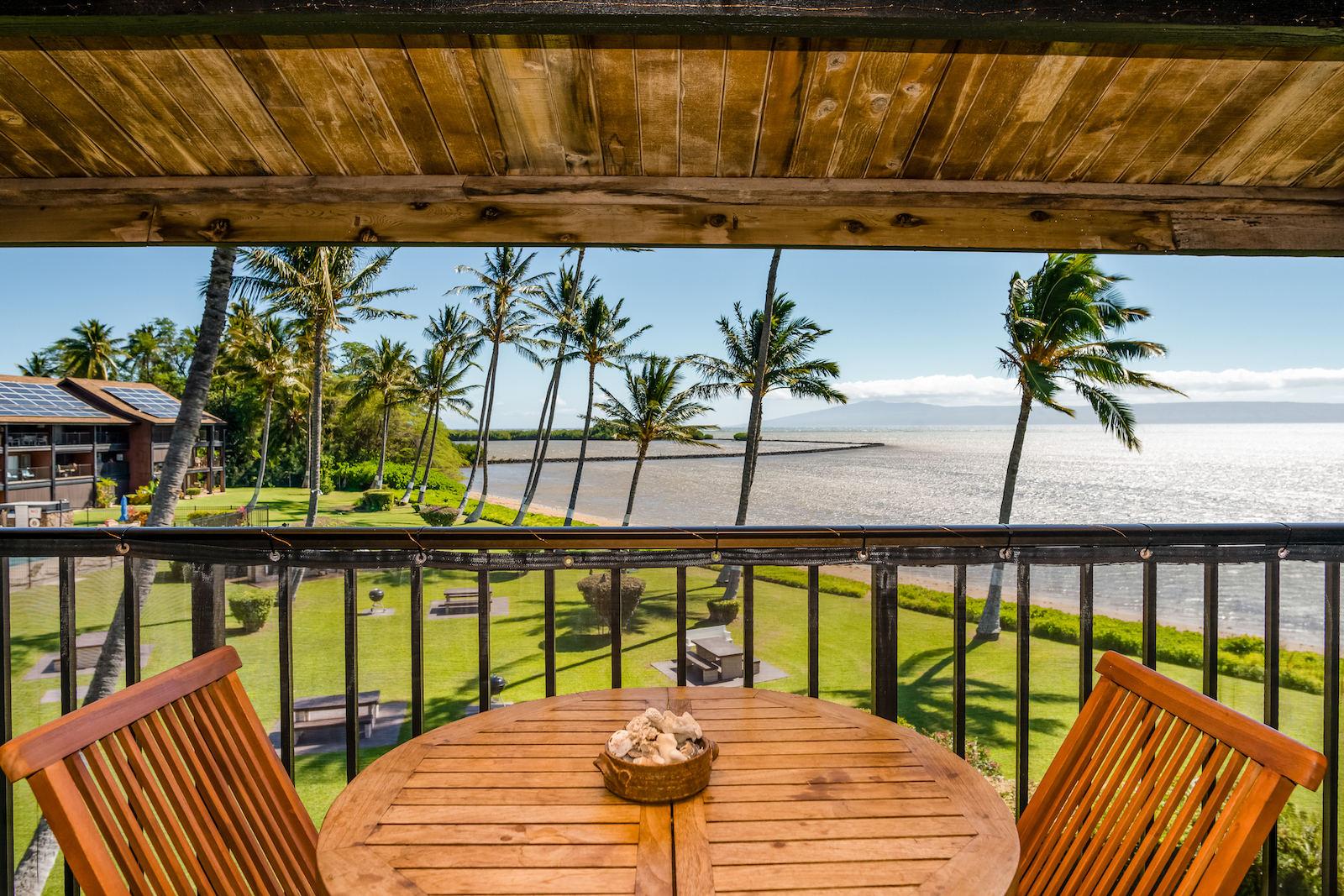 The deck overlooking the ocean at a vacation rental condo in Hawaii.