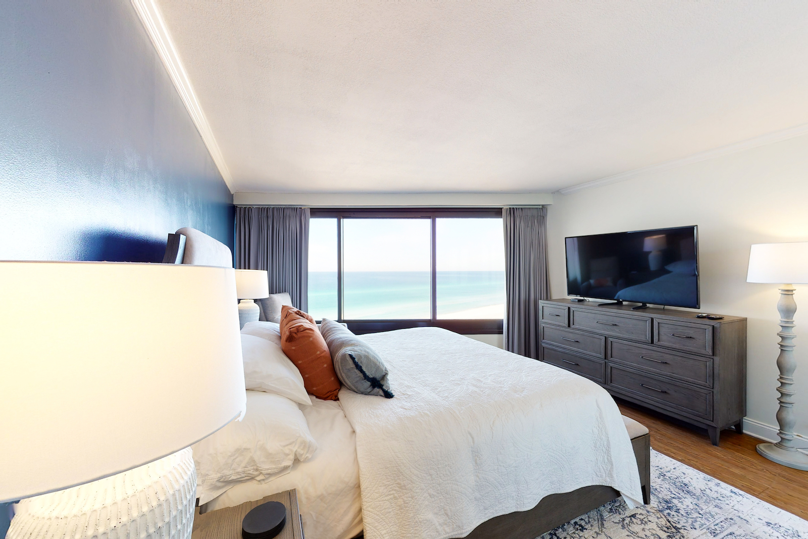 The bedroom of a vacation rental in Miramar Beach, Florida overlooking the Emerald Coast.