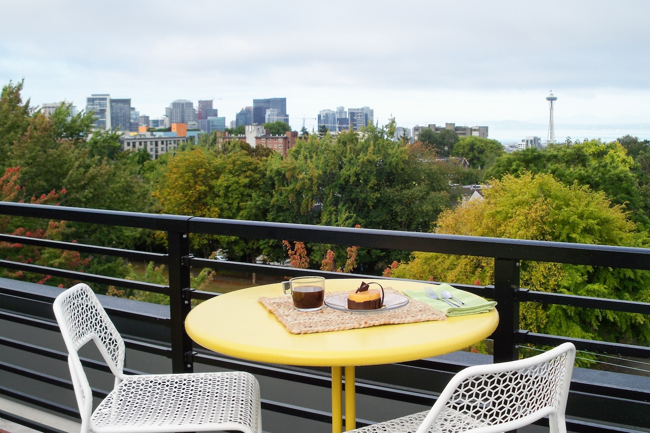 A table and two chairs overlooking Seattle, WA.