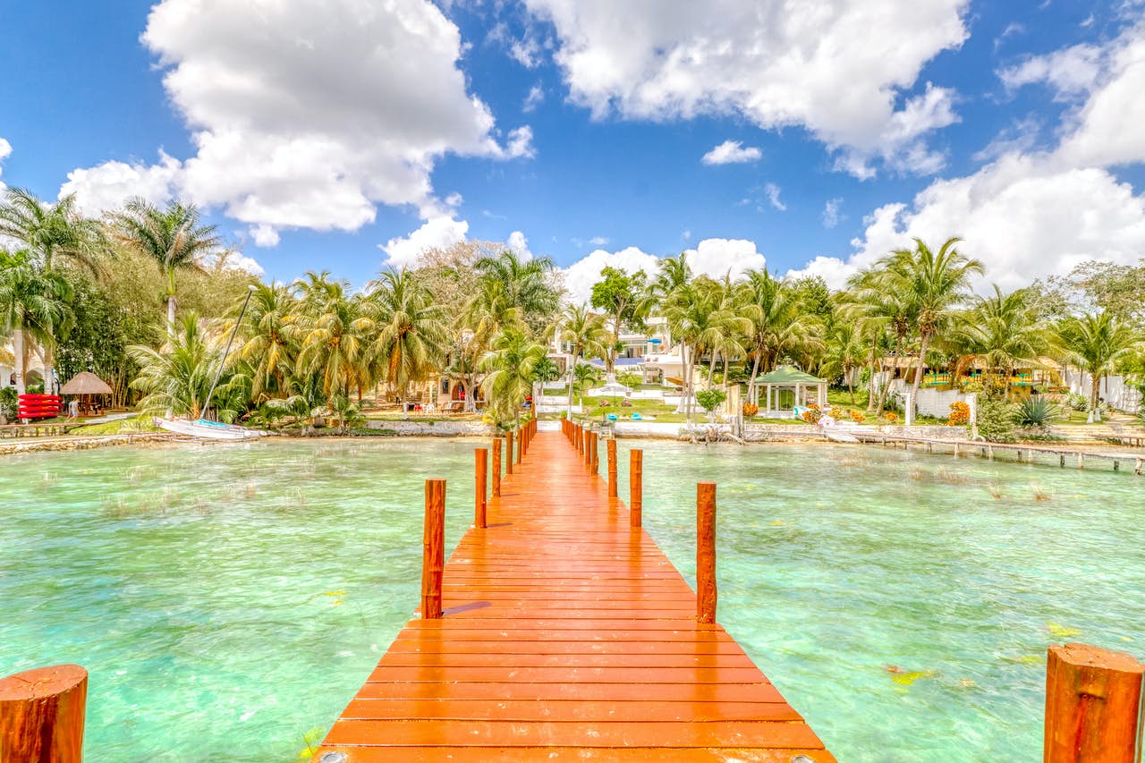 dock over crystal clear water in Bacalar, Quintana Roo