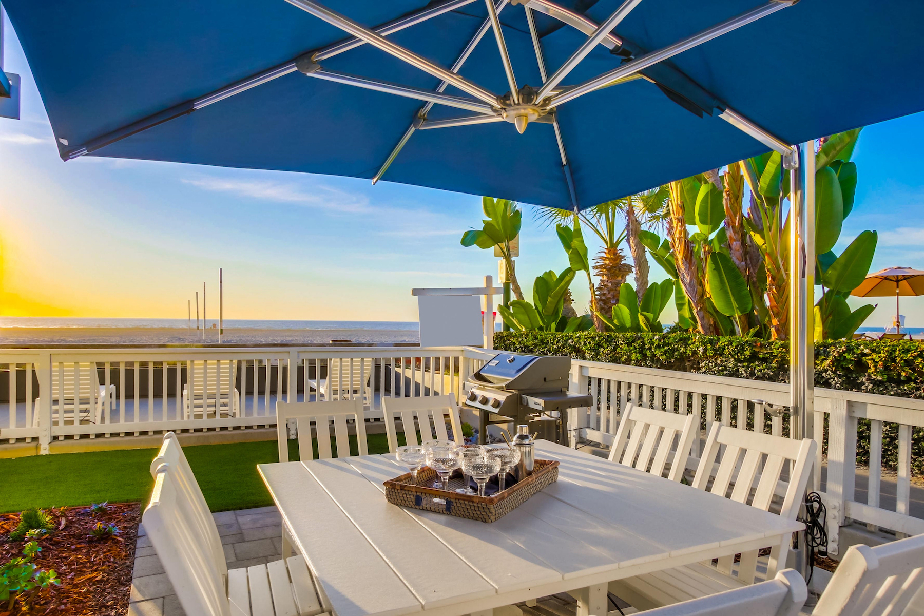 The private deck of a beachside vacation rental in San Diego, CA with a bbq and more.
