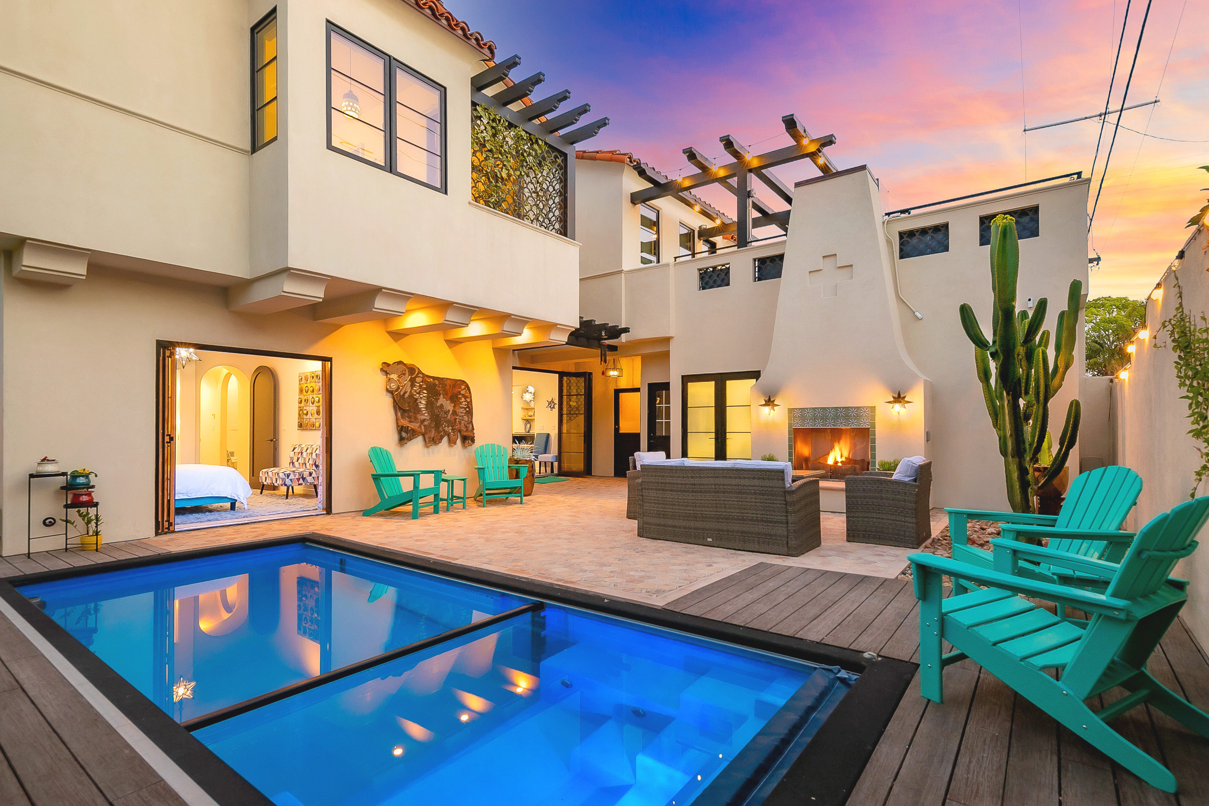 Exterior pool deck of a California home with pool and sunset sky