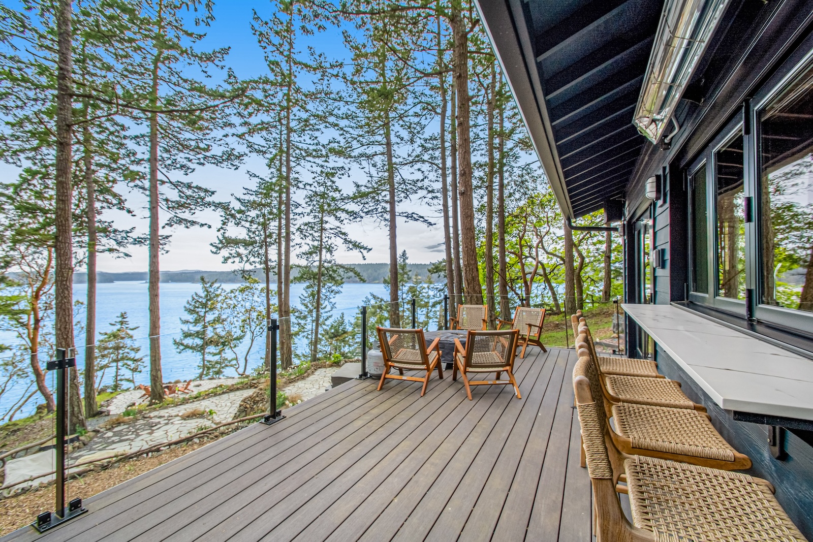 The back deck area overlooking the water at a Lopez Island, WA rental.