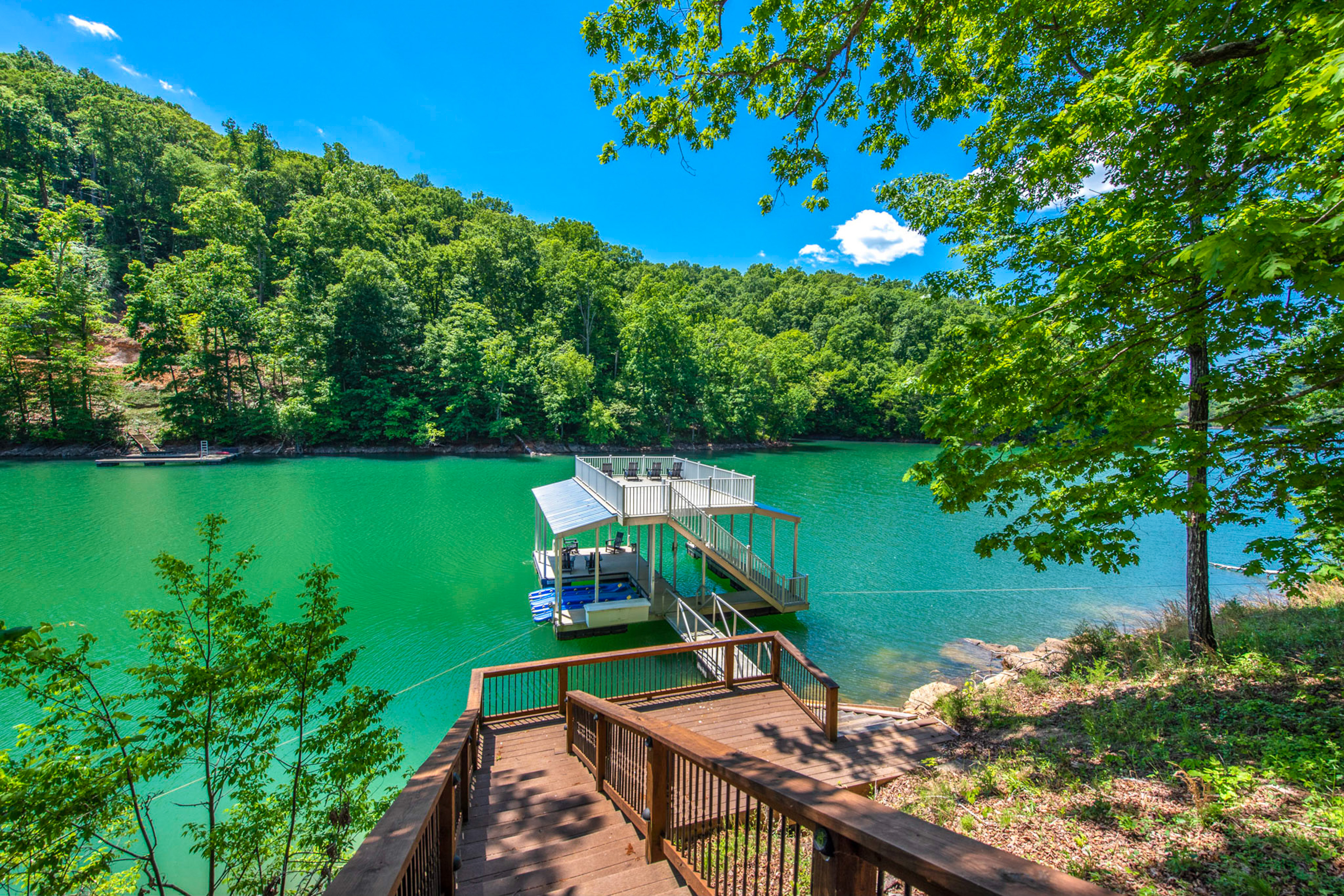 private dock on norris lake with seating and rooftop terrace with chairs