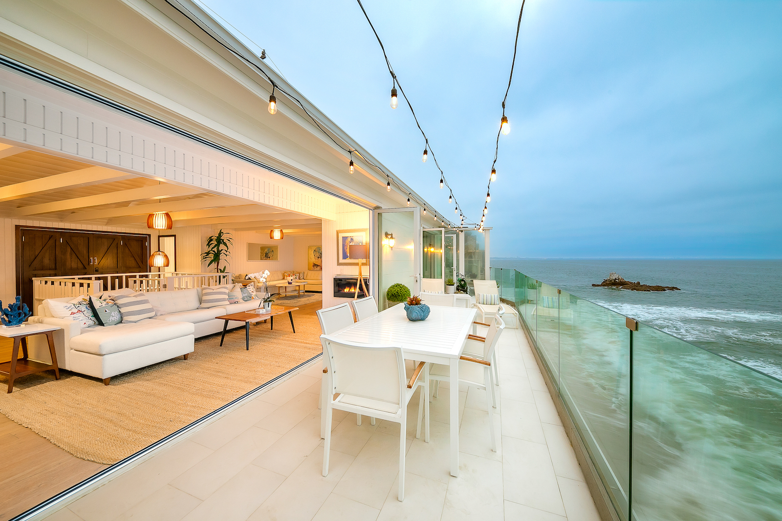 An oceanside deck with seating at a vacation rental in Malibu, CA.