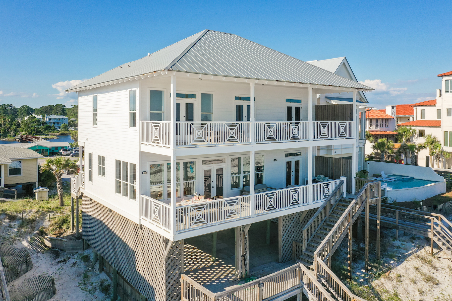 The exterior of a white two story vacation rental in Santa Rosa Beach, Fl.