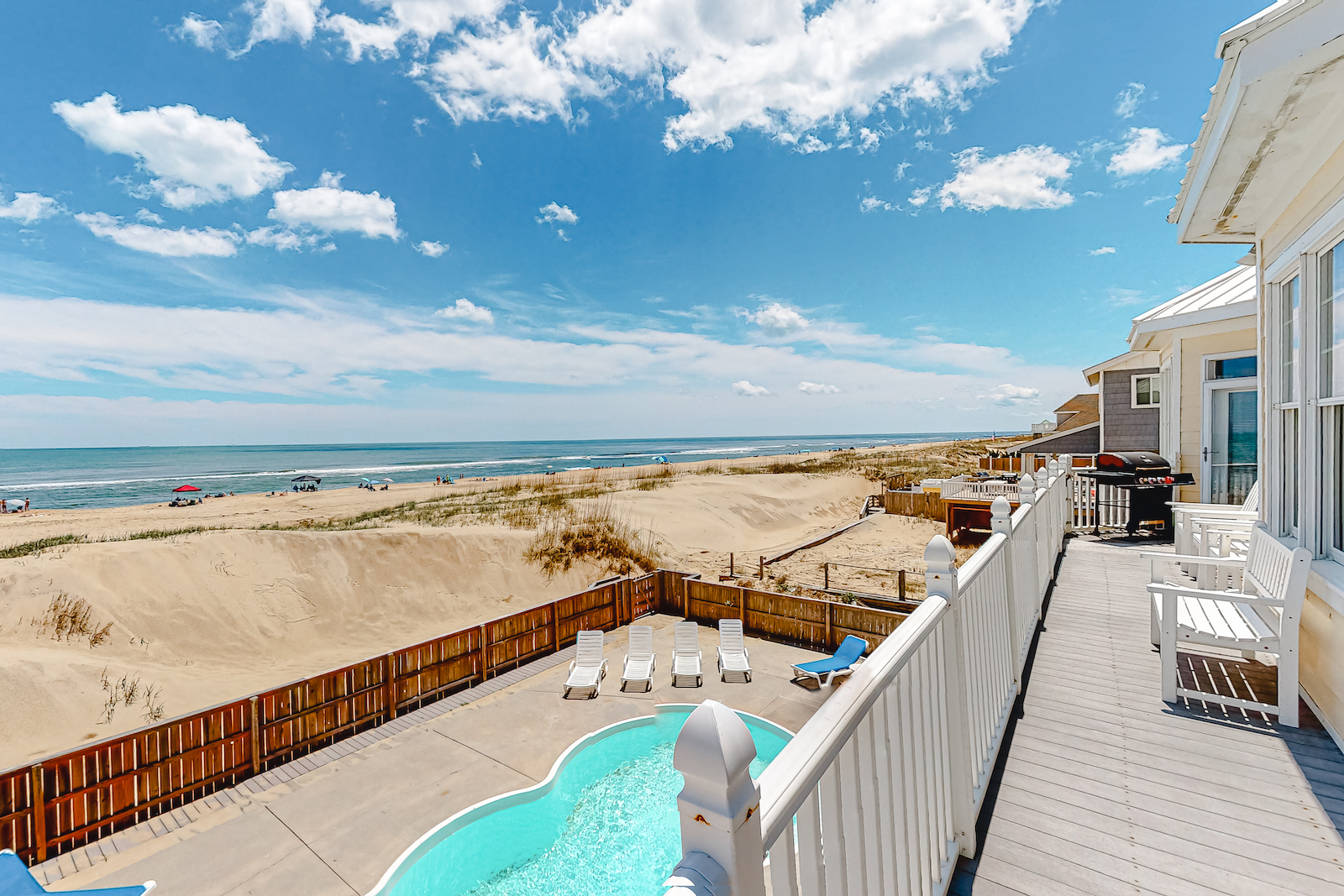 The view from a balcony overlooking the coastline and a private pool at a vacation rental in Virginia Beach.