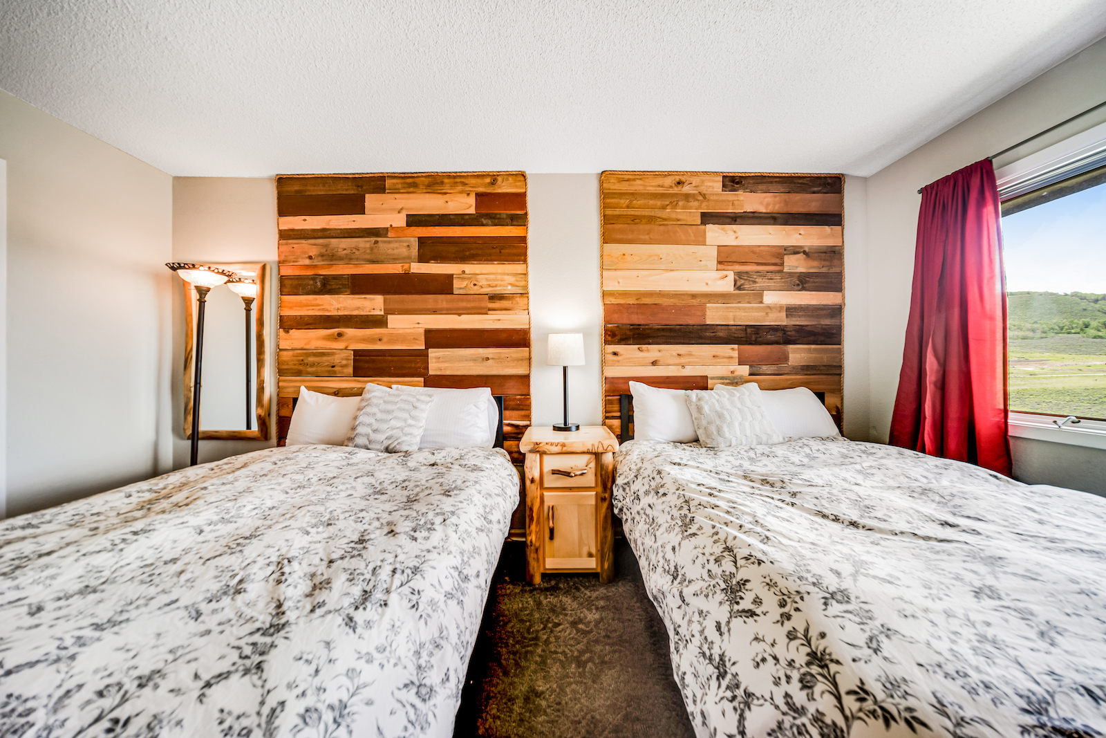 A bedroom with two beds and elegant design in a vacation rental in Granby, CO.