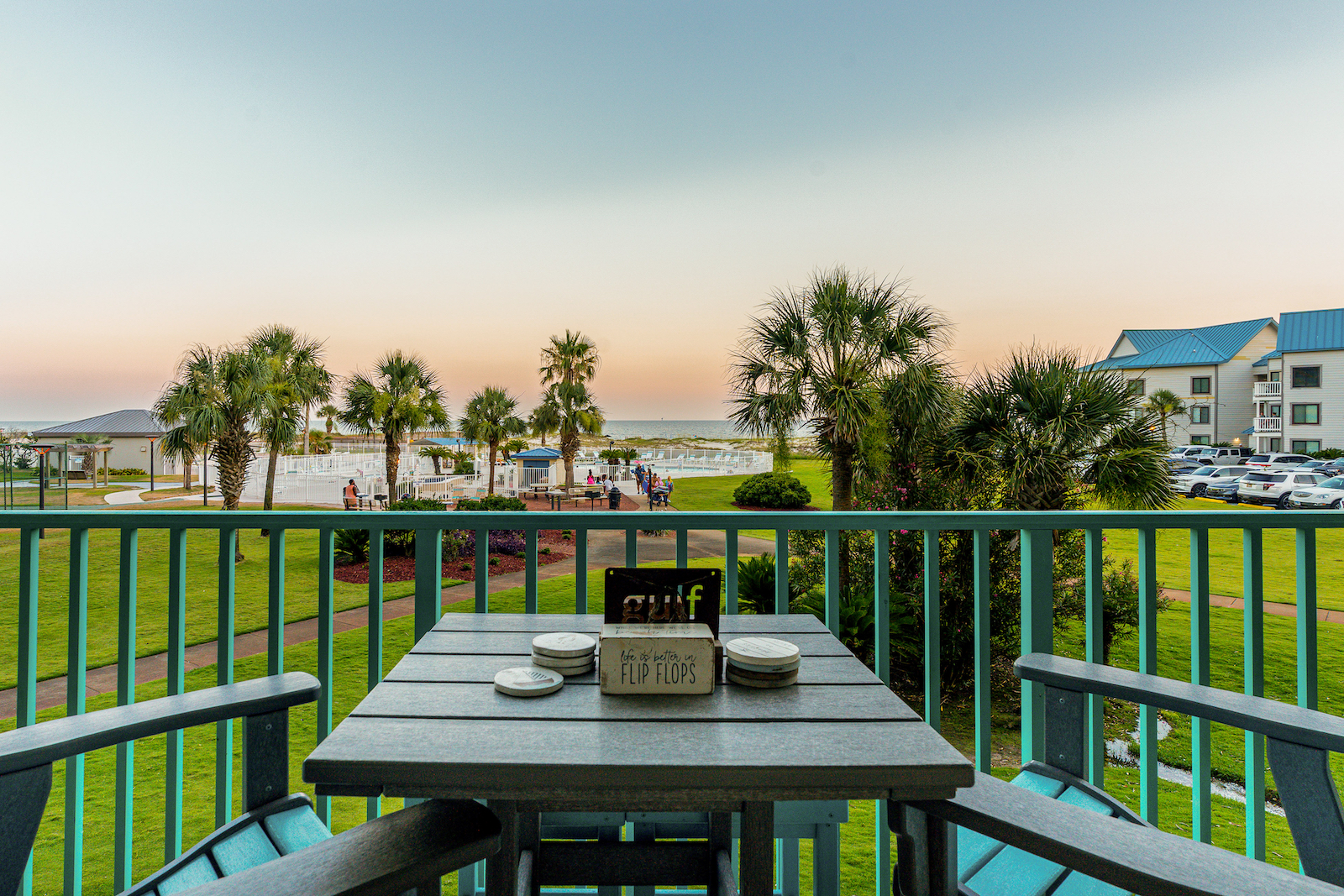 A table with chairs overlooking the beach at a vacation rental in Plantation Palms in Fort Morgan.