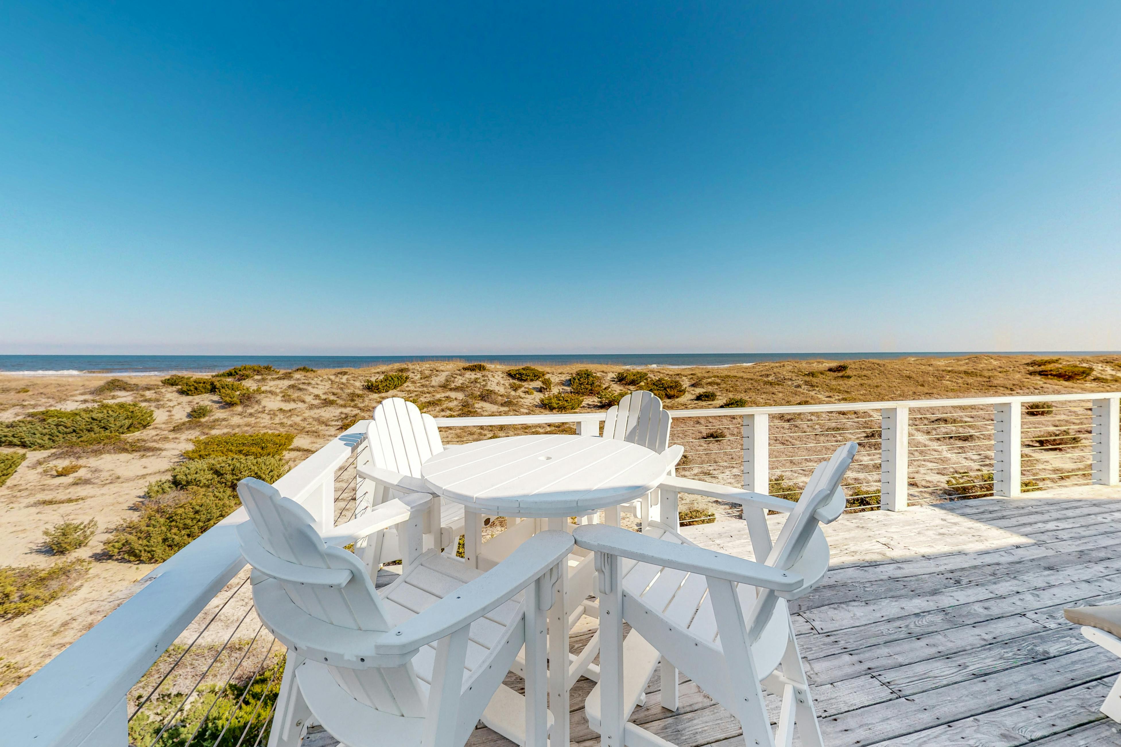 View of the beach and ocean from the deck of an Outer Banks vacation rental