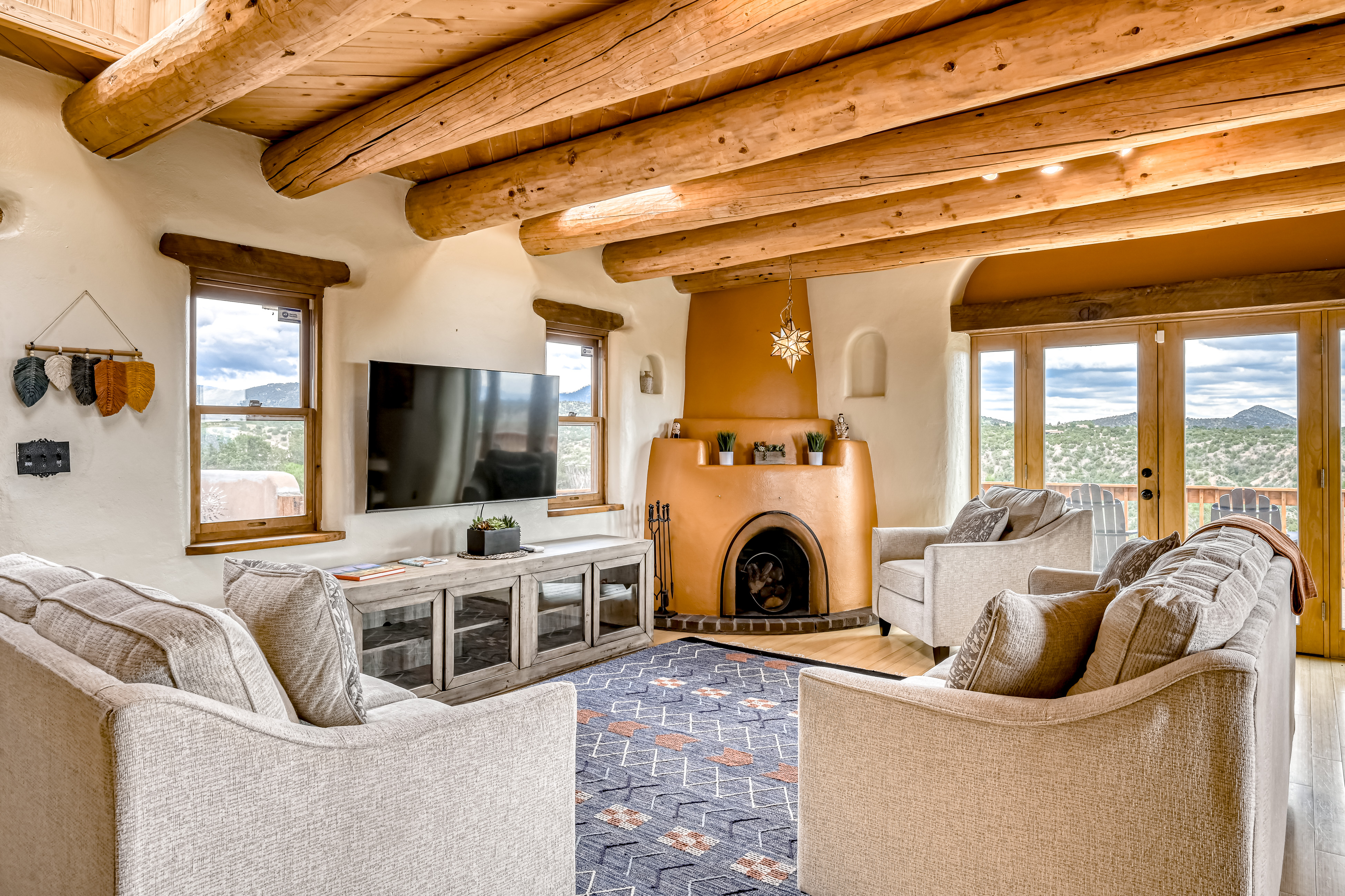 living space of santa fe vacation home with large fireplace and sliding glass doors leading to balcony