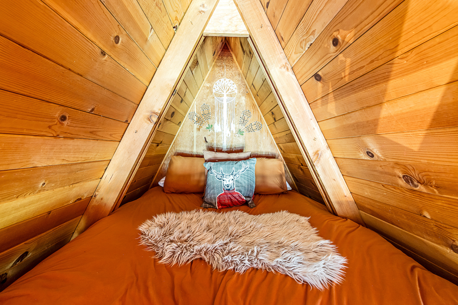 A bedroom of a a-frame cabin rental in Arnold, California.