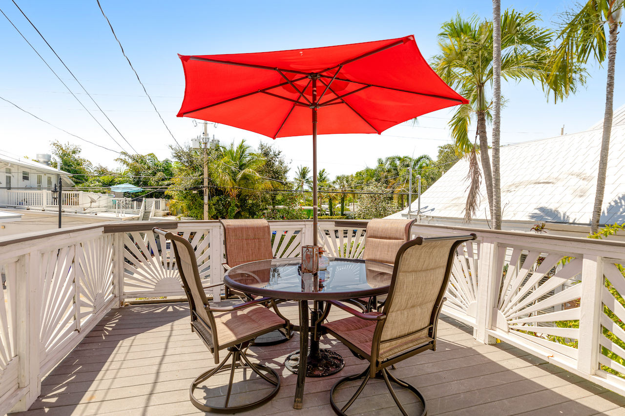 The deck with table and chairs at a rental in Key West.