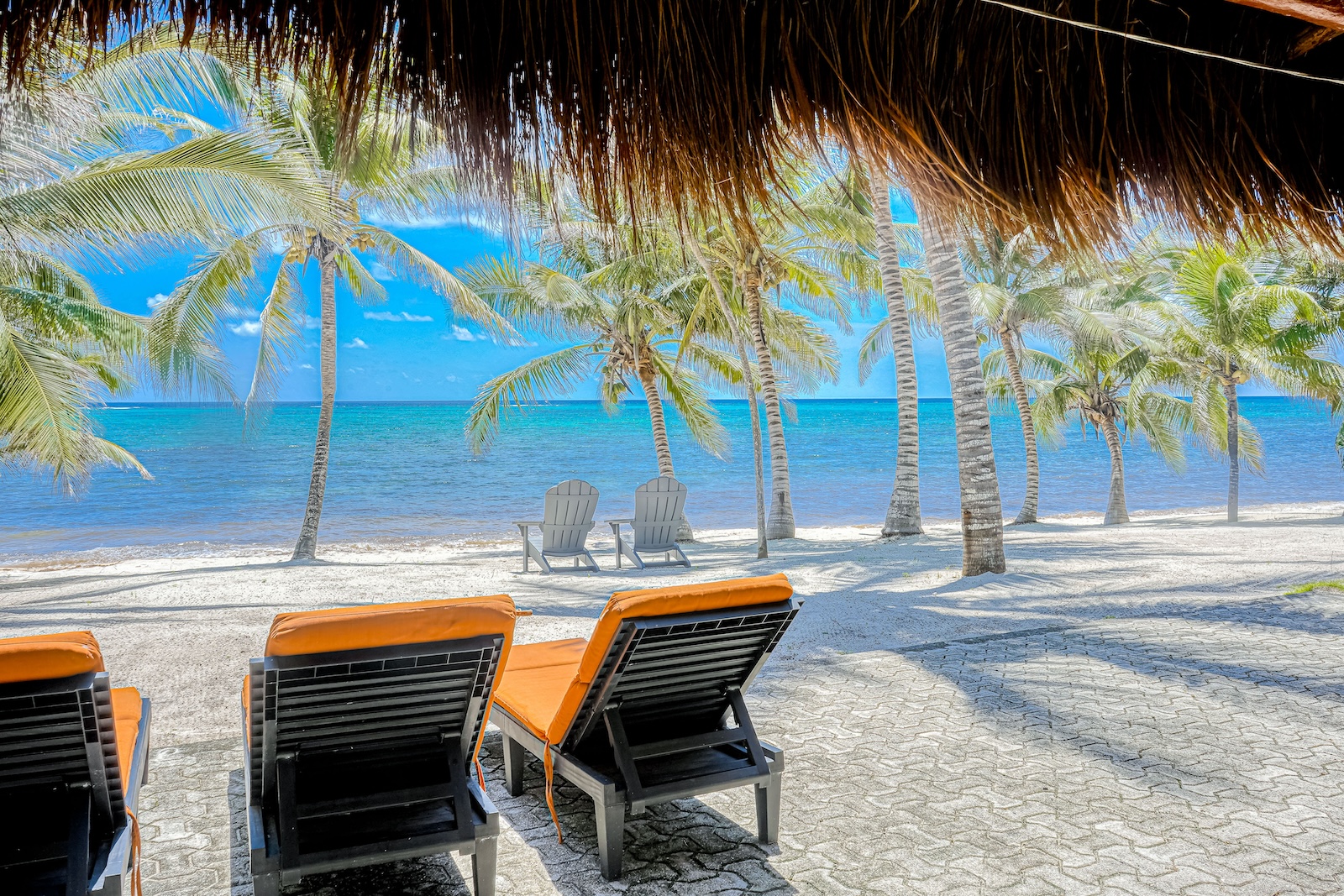 Beach chairs on a beach at a rental in Tulum.
