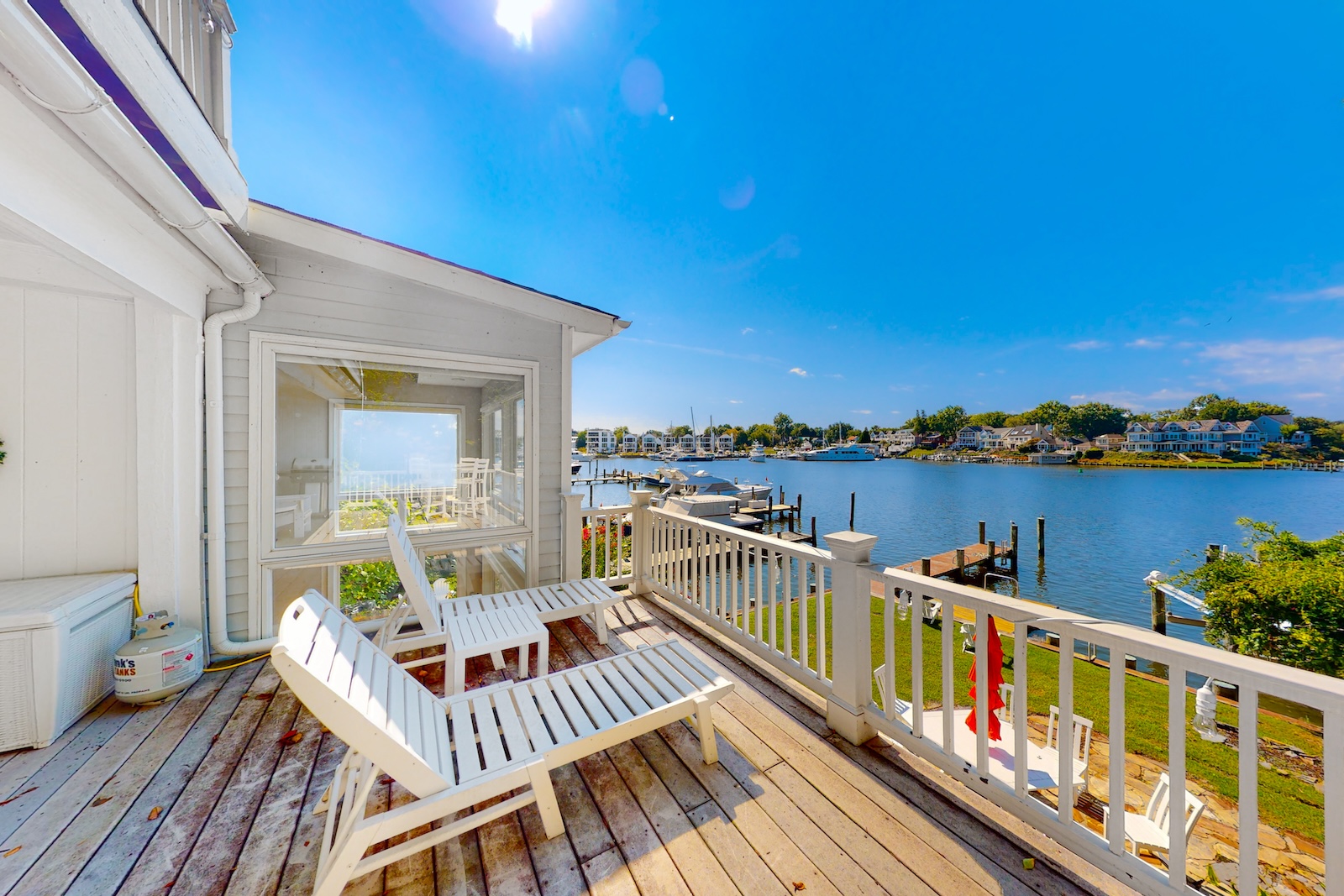 View from a deck with chairs overlooking water.