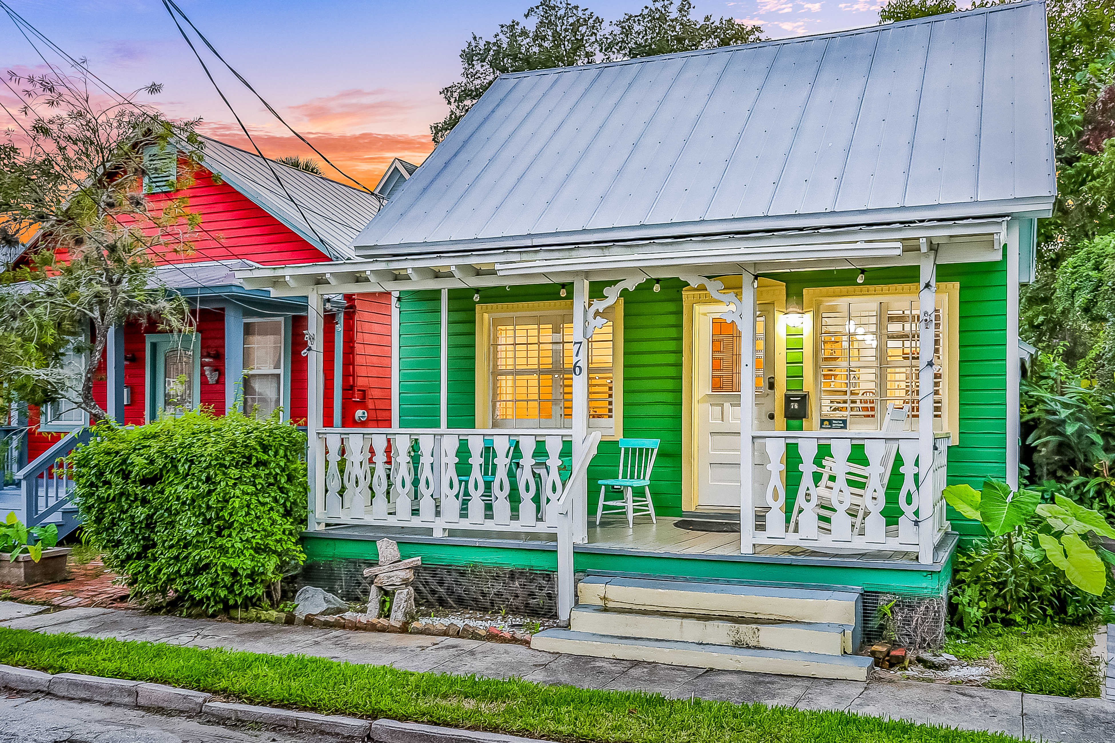 a quaint green house next to a red house in st. augustine, florida