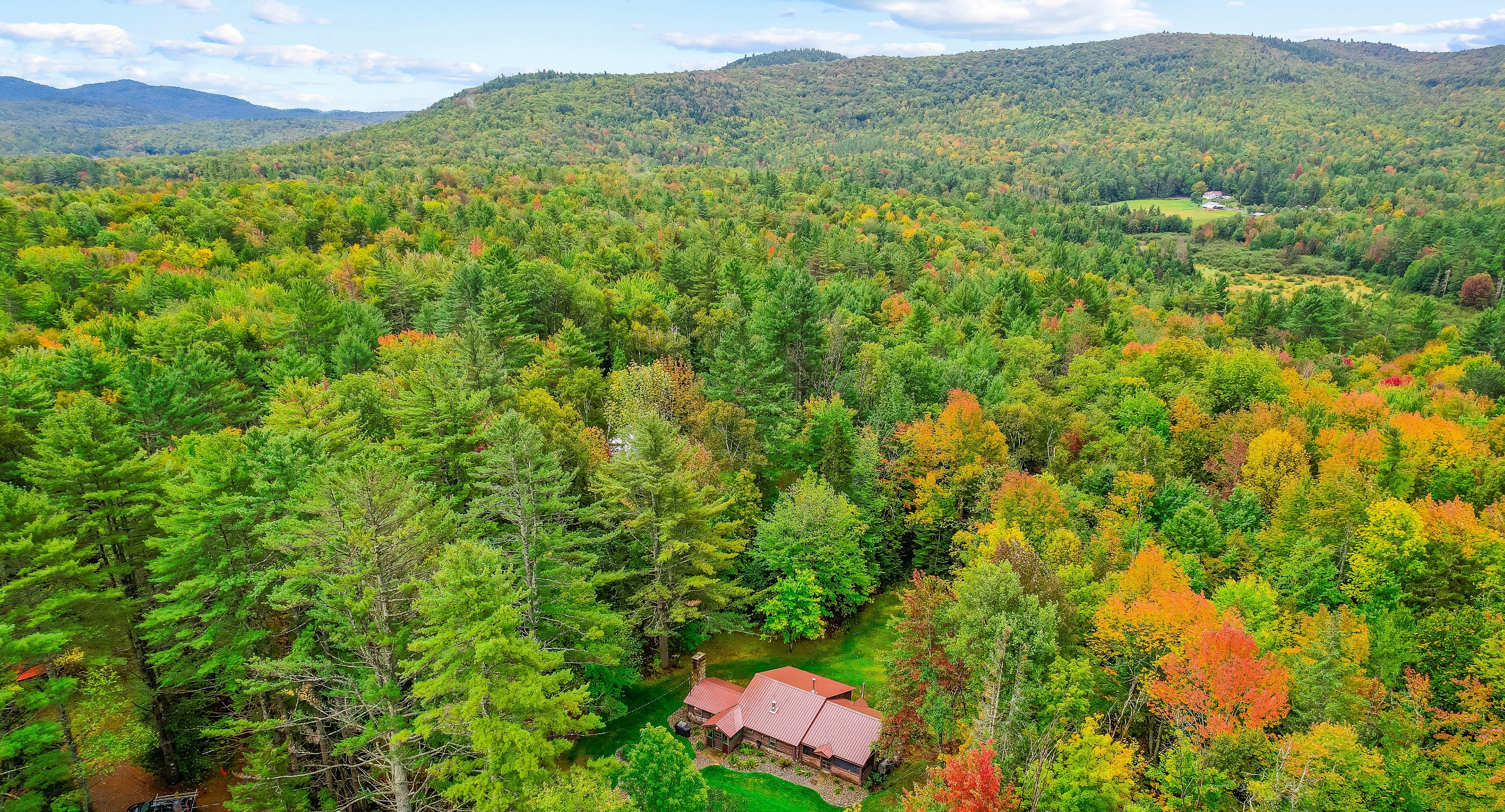 Drone shot of a vacation rental in the fall in the Adirondacks.