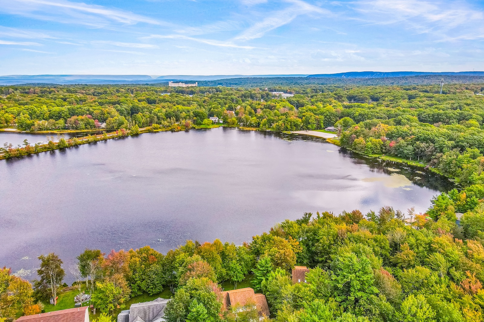 Drone shot of a lake and homes in the Poconos.