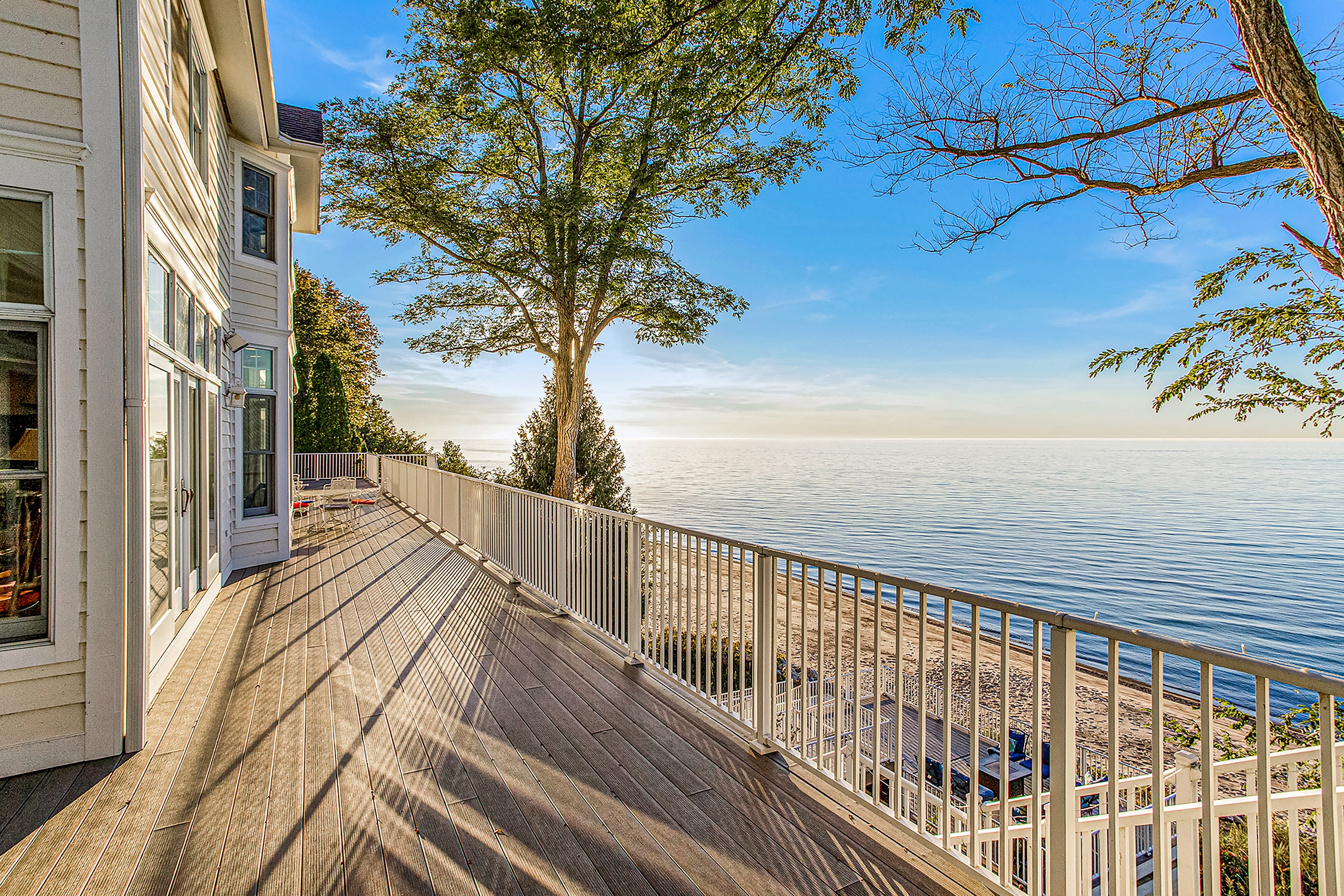 view of lake michigan off the back deck of vacation home at sunset