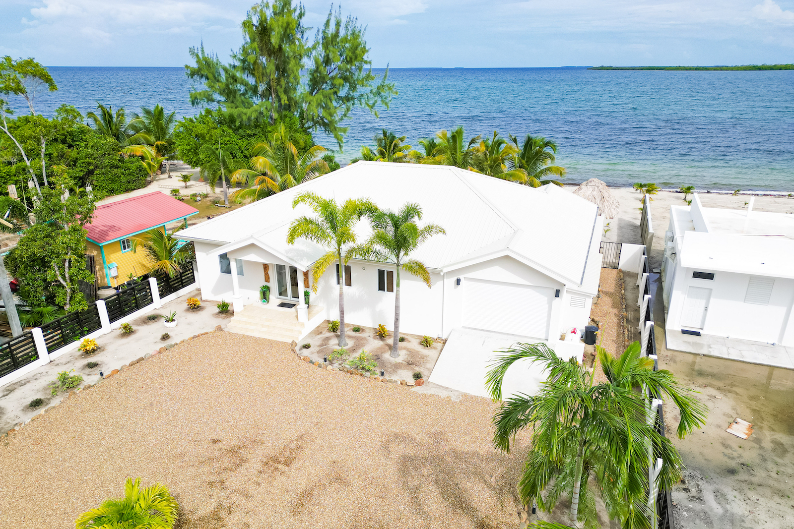 Aerial shot of a white vacation home near the beach in Belize.