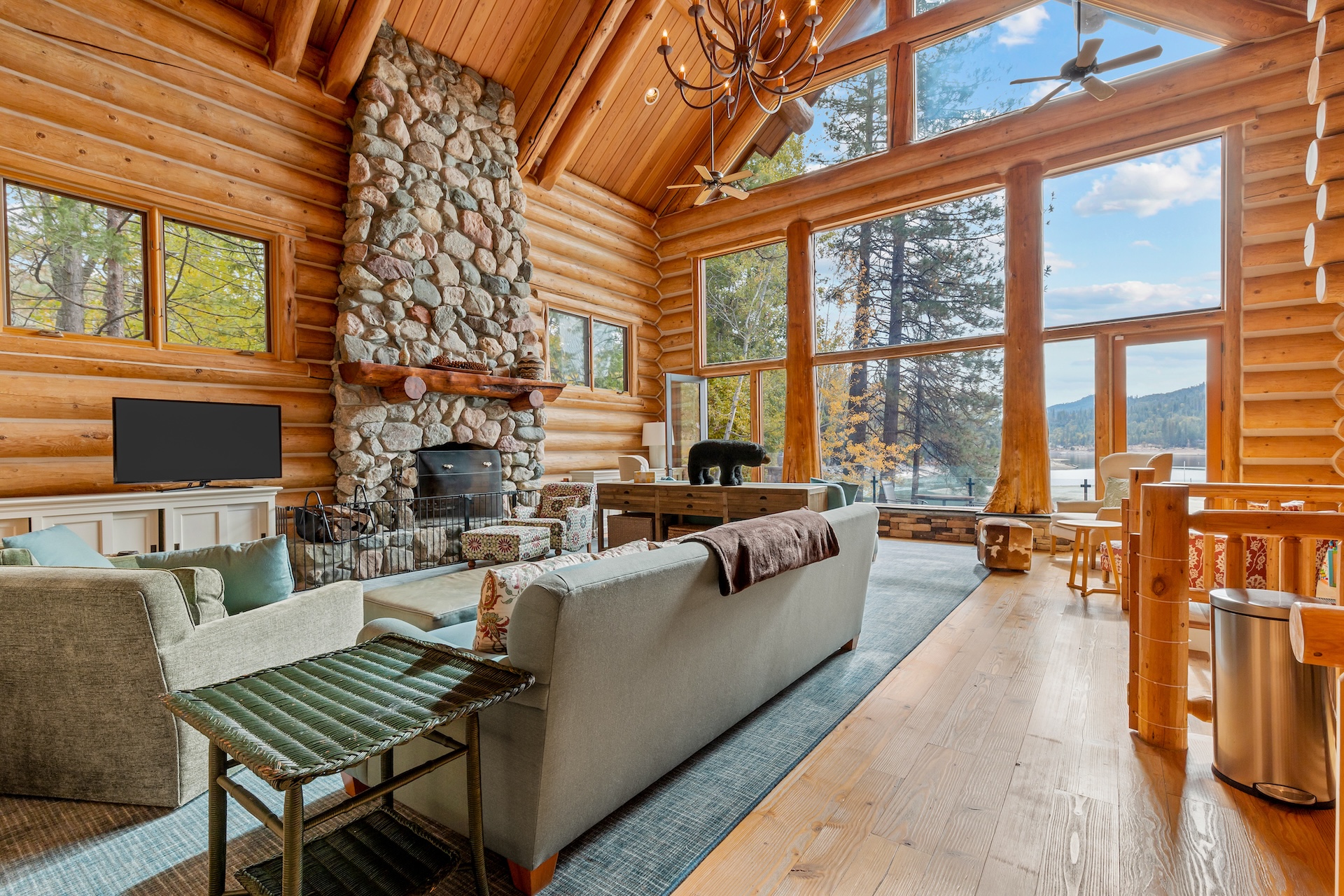 The living room of a large cabin overlooking the lake of Bass Lake, CA.