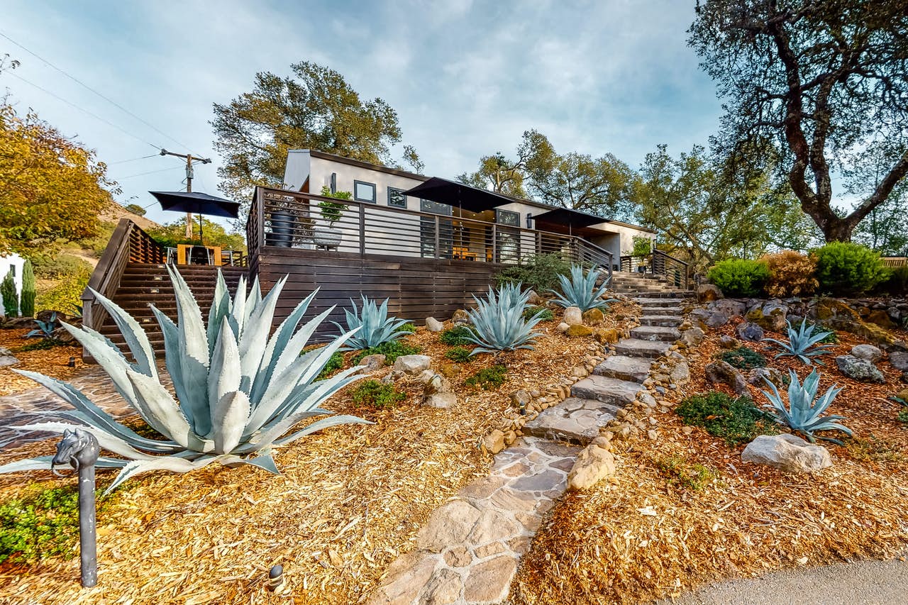 Vacation rental home in Sonoma, CA with a wooden patio and sun umbrellas.