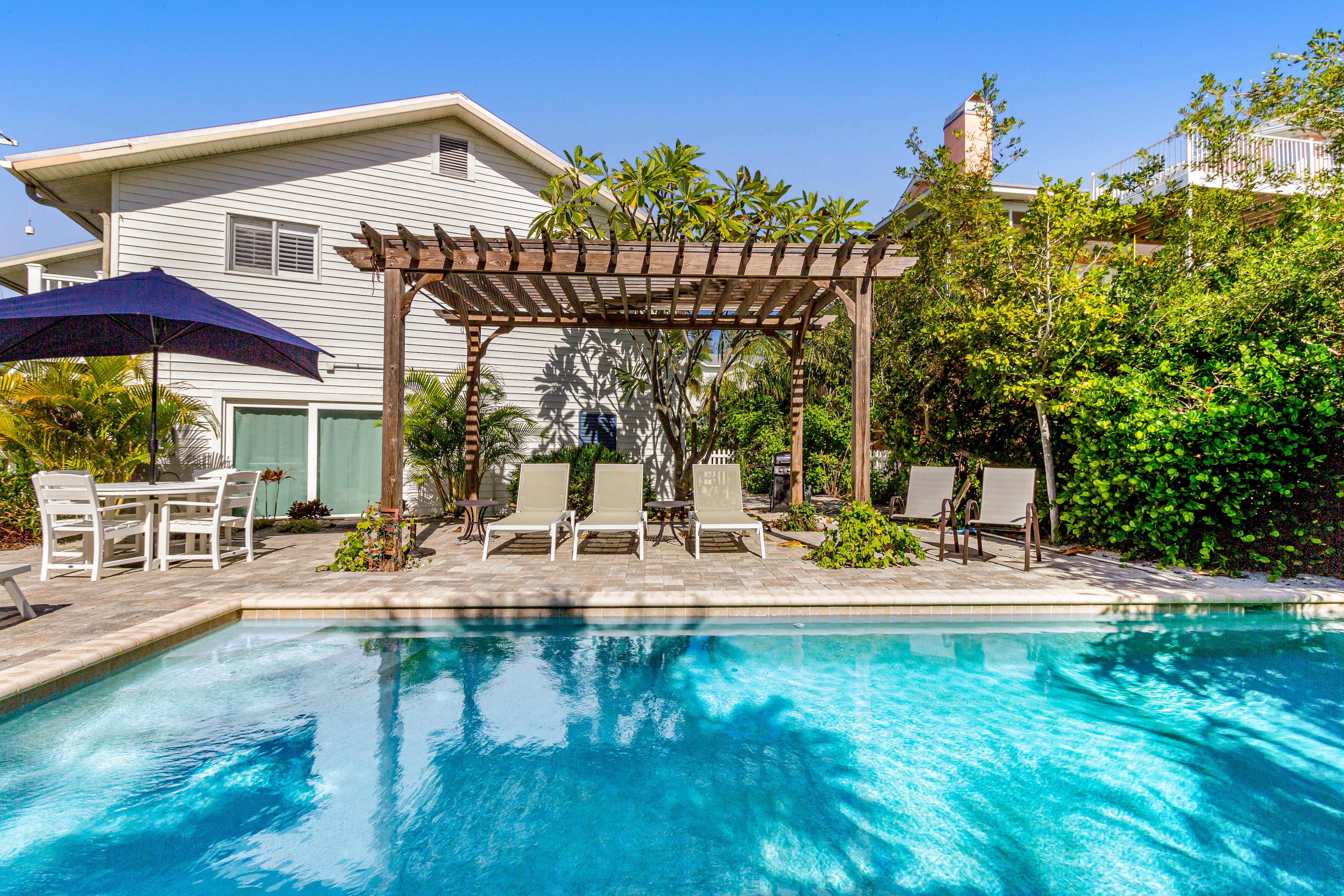 Cottage in Anna Maria, Florida with private pool surrounded by lounge chairs