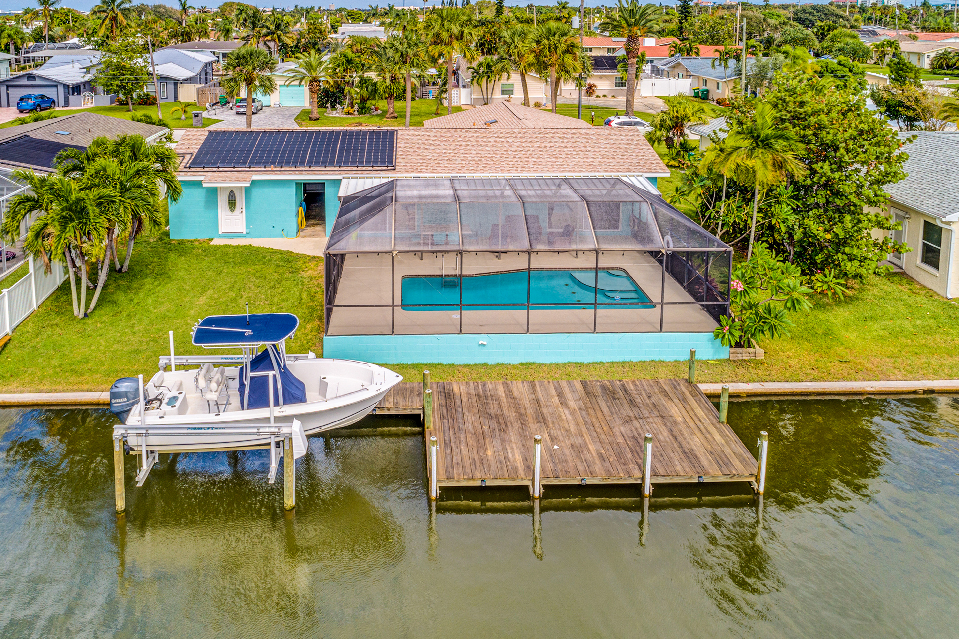 vacation home with private pool and dock in florida with a lifted boat