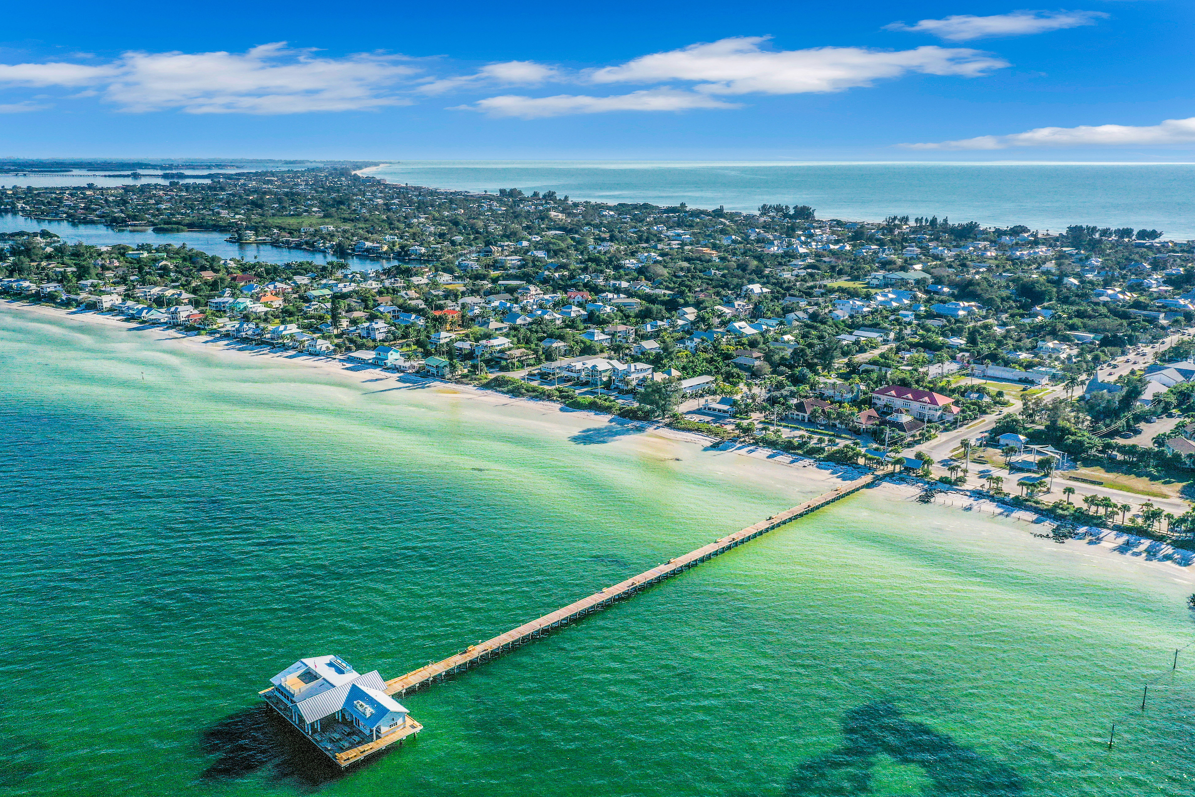 Long pier over the waters of the Gulf of Mexico connects to Anna Maria Island