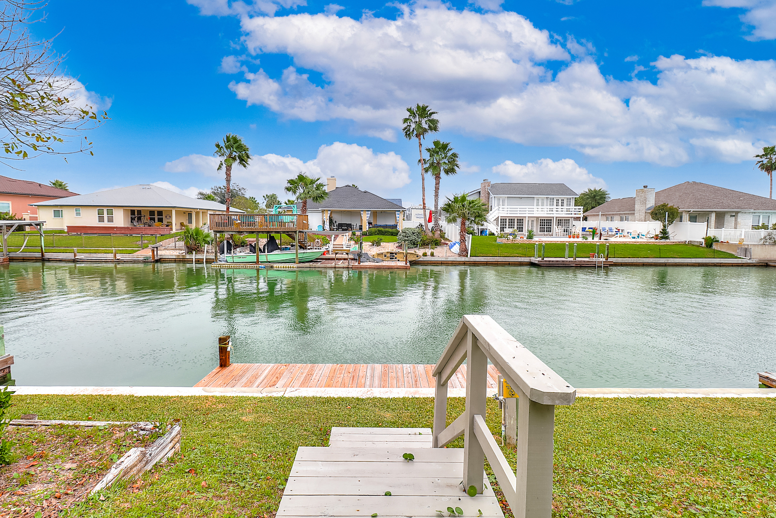 Steps down to a dock on a canal at a vacation rental in Corpus Christi.