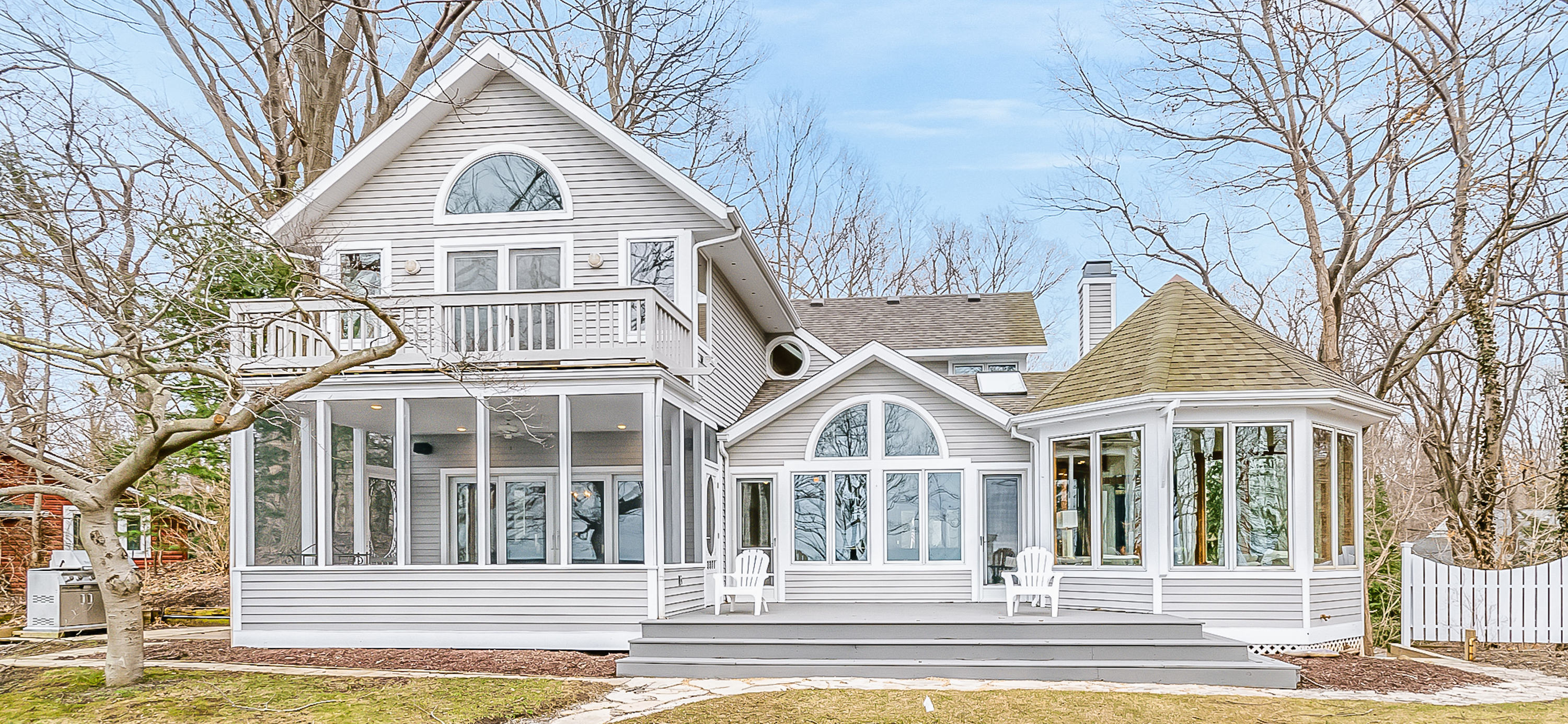 michigan home with balcony and numerous windows