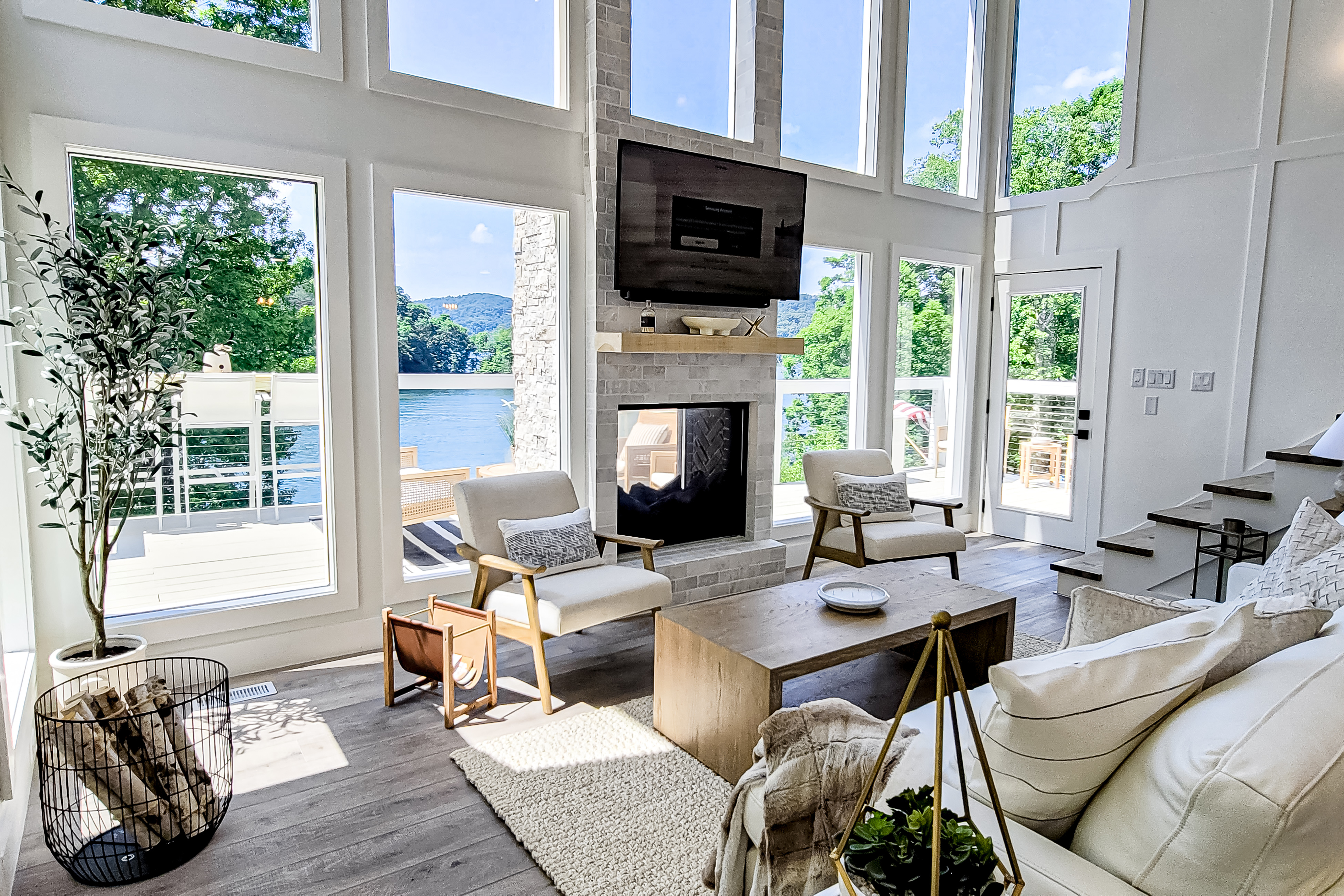 a wall of waterfront windows brings in plenty of natural light highlighting the beautiful interior of this Tennessee home