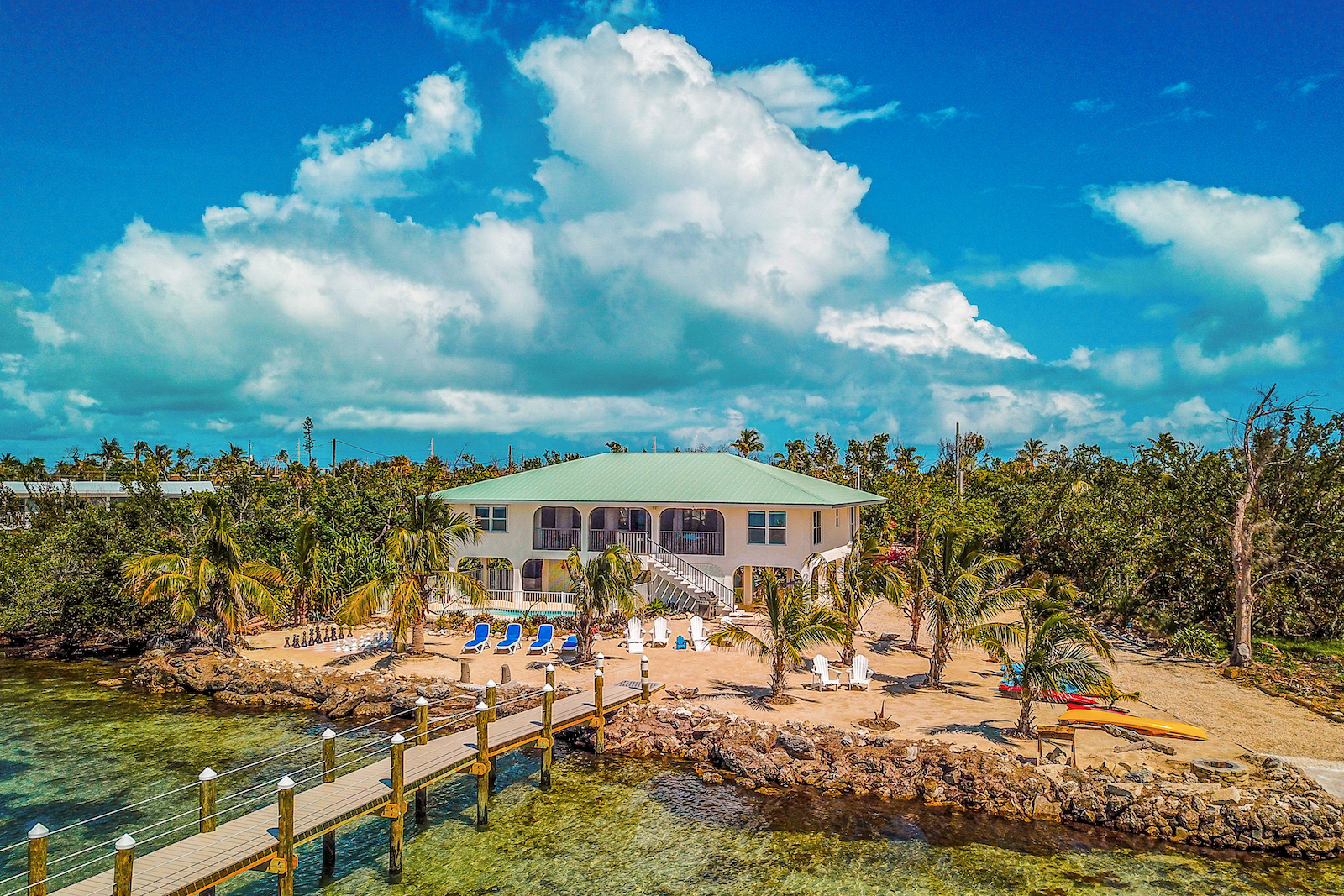 The back area of a vacation rental with a beach and a dock in the Middle Keys, Florida.