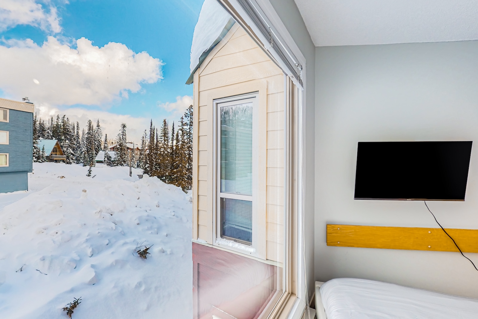 Exterior and interior living space of a vacation rental on Big White Mountain, BC.