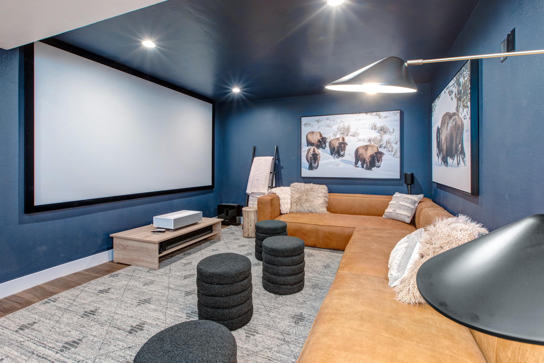 A theater room with a buffalo painting and elegant design at a vacation rental in Park City.