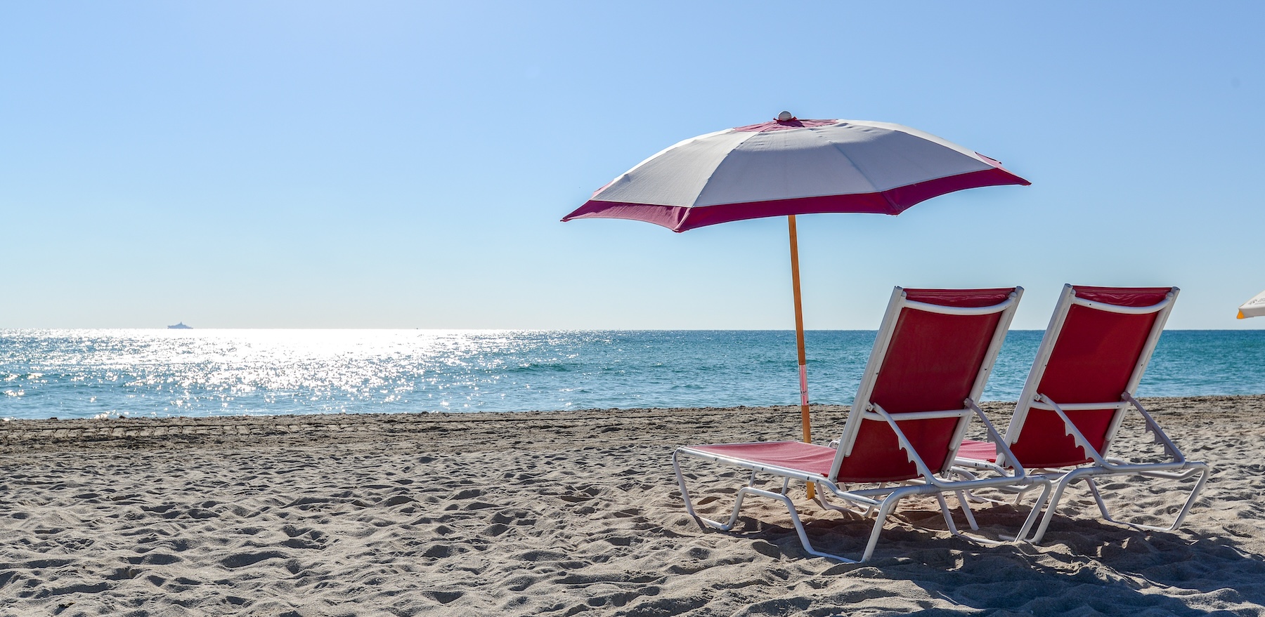 Miami Beach with two chairs and a umbrella.