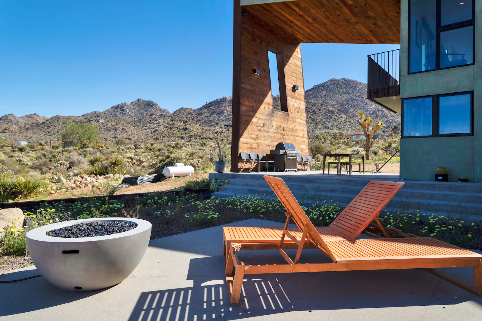 The fire area with two chairs at a modern vacation rental in Joshua Tree, CA.