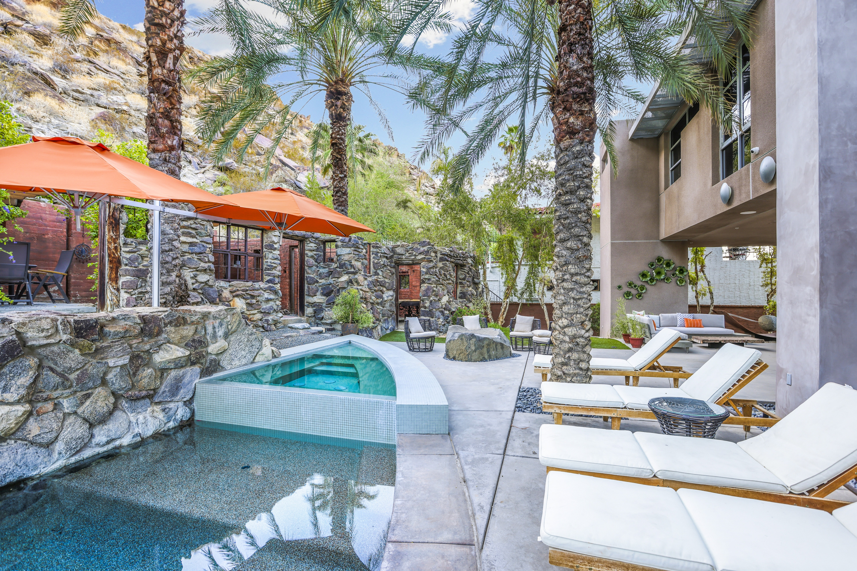 a resort pool and lounge chairs in palm springs