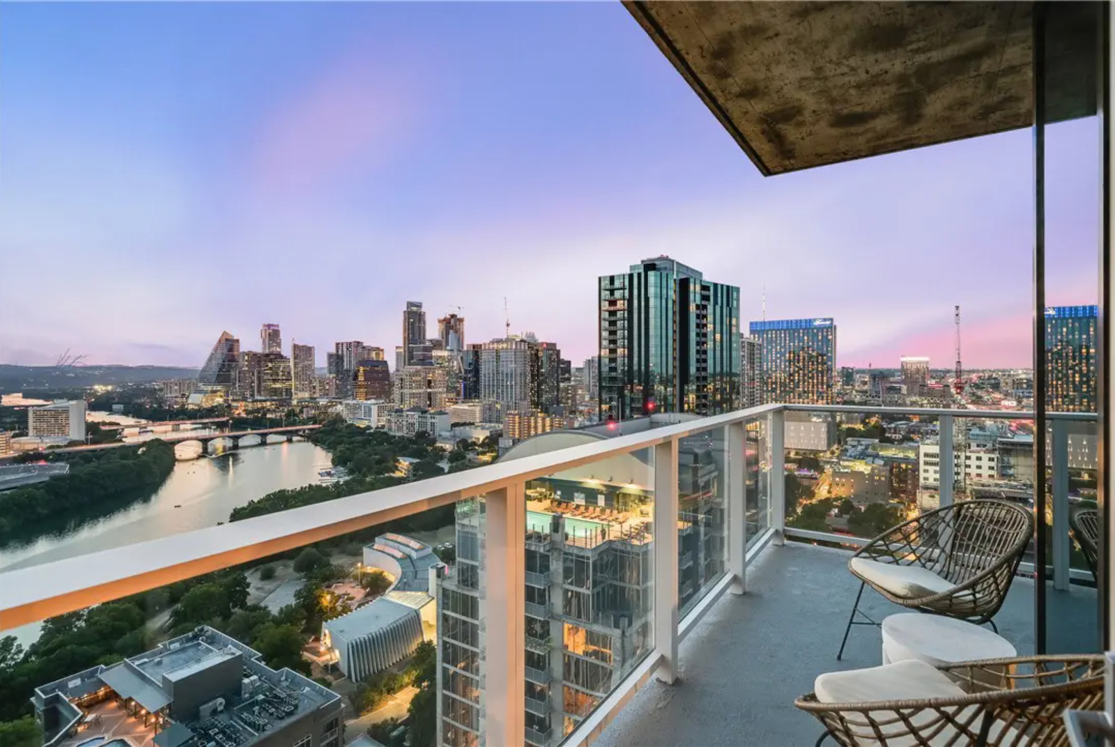 The balcony of a vacation rental property in Austin, TX with a stunning city view.