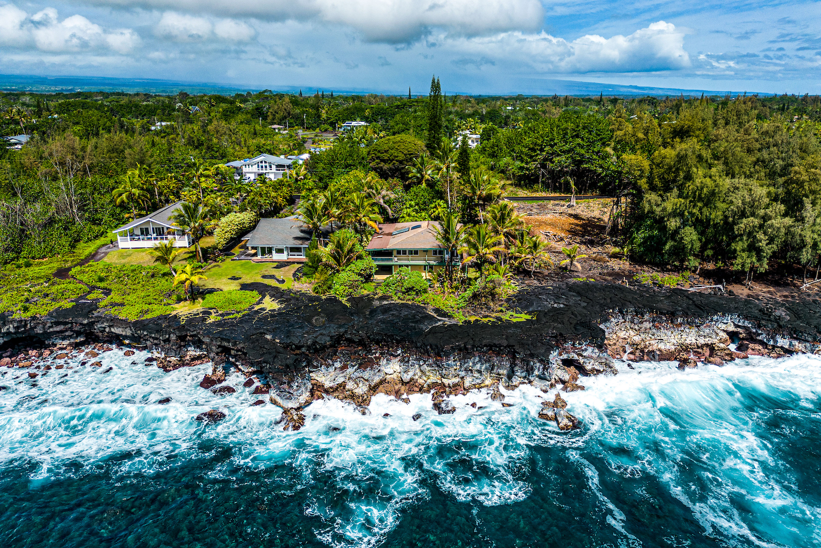 Aerial shot of vacation rentals on the coast of Keaau, HI.