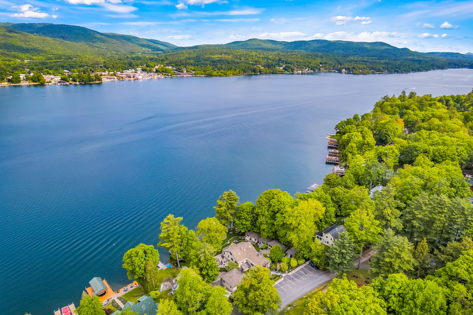 Drone shot of a Lake George, NY lined with vacation rentals.